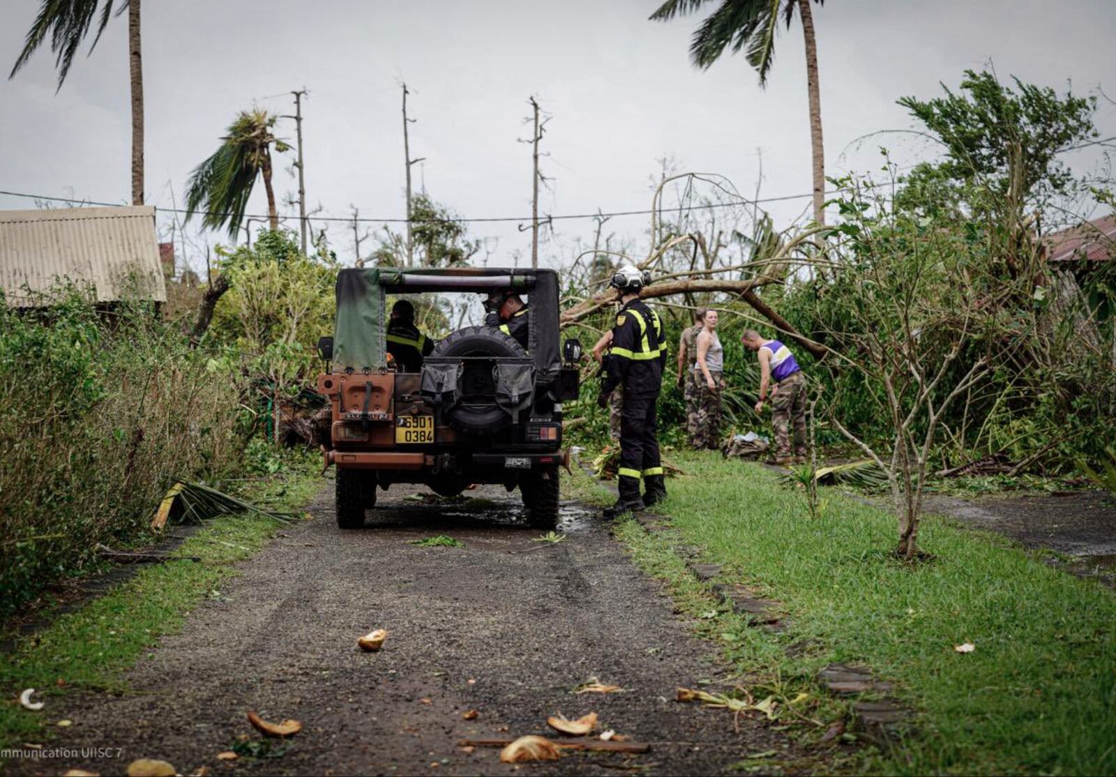 This photo provided Sunday Dec.15, 2024 by the Civil Security shows soldiers and rescue workers clearing a street in the French territory of Mayotte in the Indian Ocean, after Cyclone Chido caused extensive damage with reports of several fatalities, Saturday Dec.14, 2024. (UIISC7/Securite civile via AP)