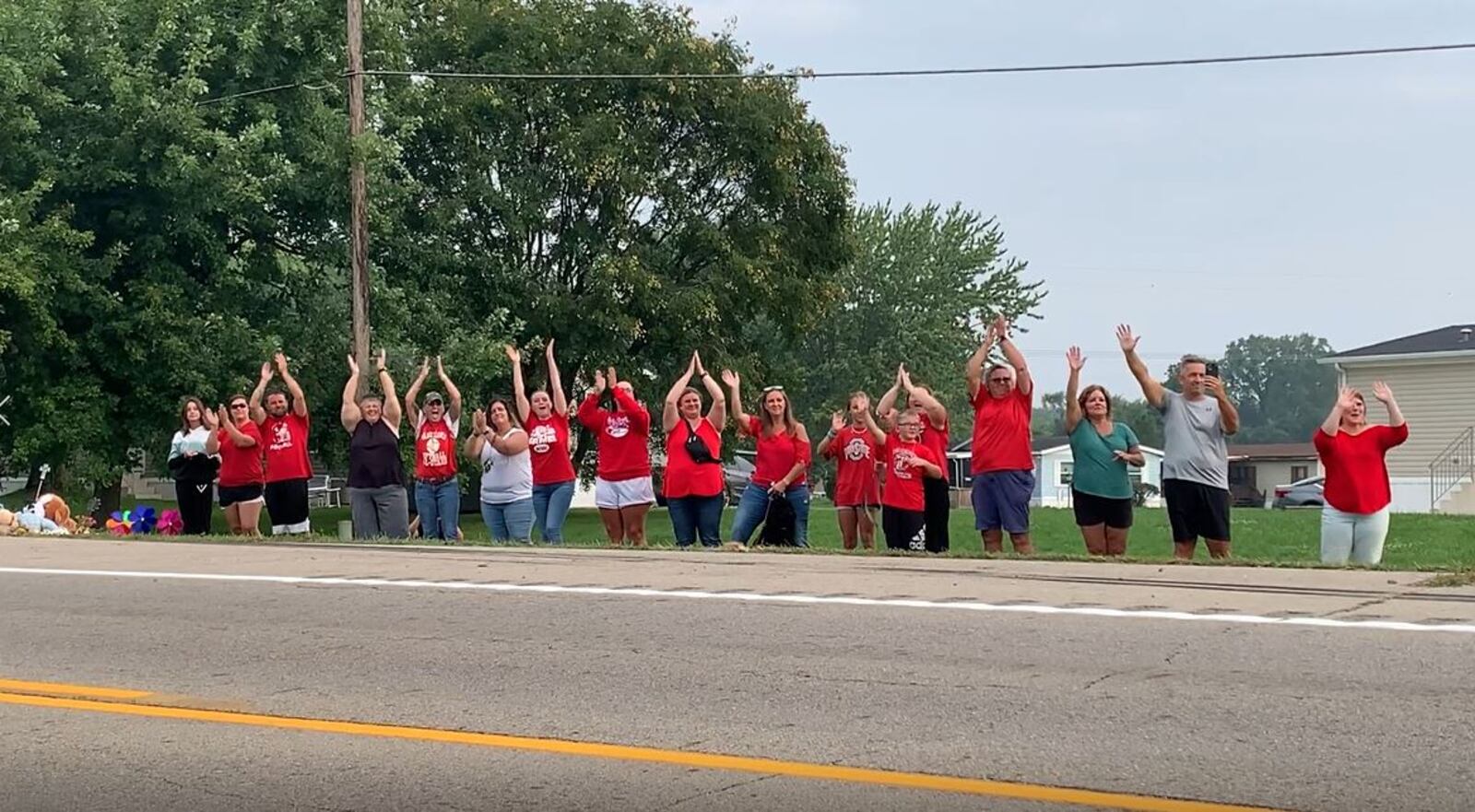 Friends and family of Northwestern students cheer on a school bus as schools reopen Friday, Aug. 25, 2023. MARSHALL GORBY/STAFF