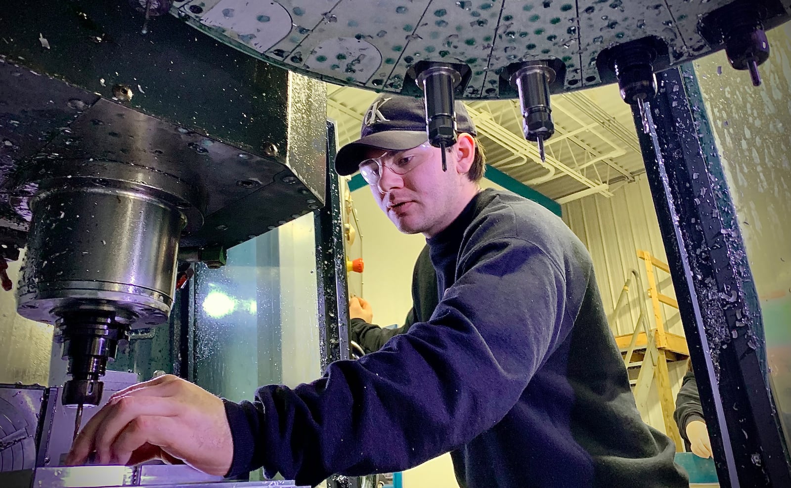 Cat-Works Metalworks employee Trenton Chambers, does set up on a machine Thursday, January 23, 2025. MARSHALL GORBY \STAFF