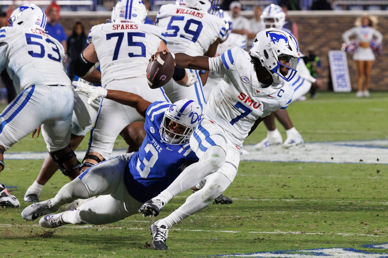 SMU's Kevin Jennings (7) carries the ball past Duke's Alex Howard (3) during the second half of an NCAA college football game in Durham, N.C., Saturday, Oct. 26, 2024. (AP Photo/Ben McKeown)