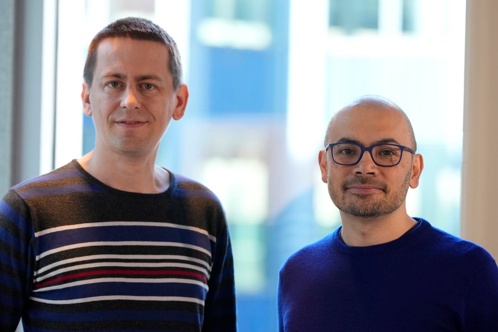 Researcher John Jumper, left, and Demis Hassabis, CEO of DeepMind Technologies, the AI division behind Gemini, speak to Associated Press at the Google DeepMind offices in London, Wednesday, Oct. 9, 2024 after being awarded with the Nobel Prize in Chemistry.(AP Photo/Alastair Grant)