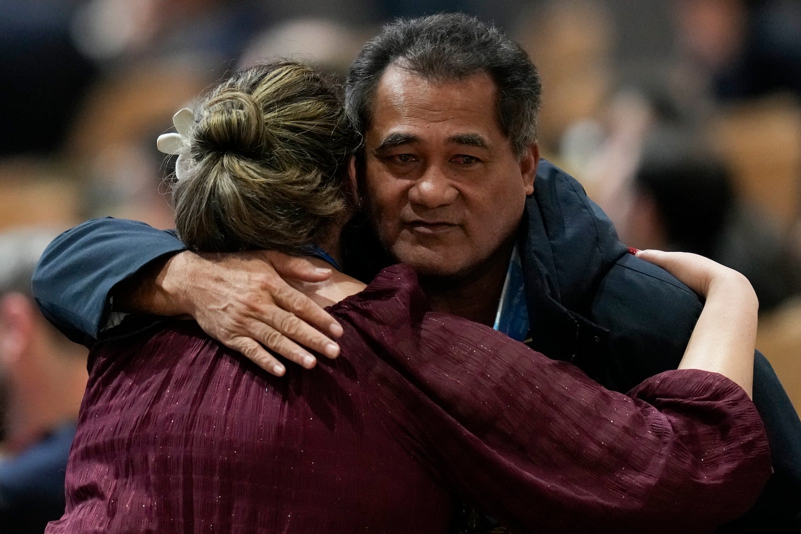 Toeolesulusulu Cedric Schuster, Samoa environment minister, right, embraces an attendee during a closing plenary session at the COP29 U.N. Climate Summit, Sunday, Nov. 24, 2024, in Baku, Azerbaijan. (AP Photo/Rafiq Maqbool)