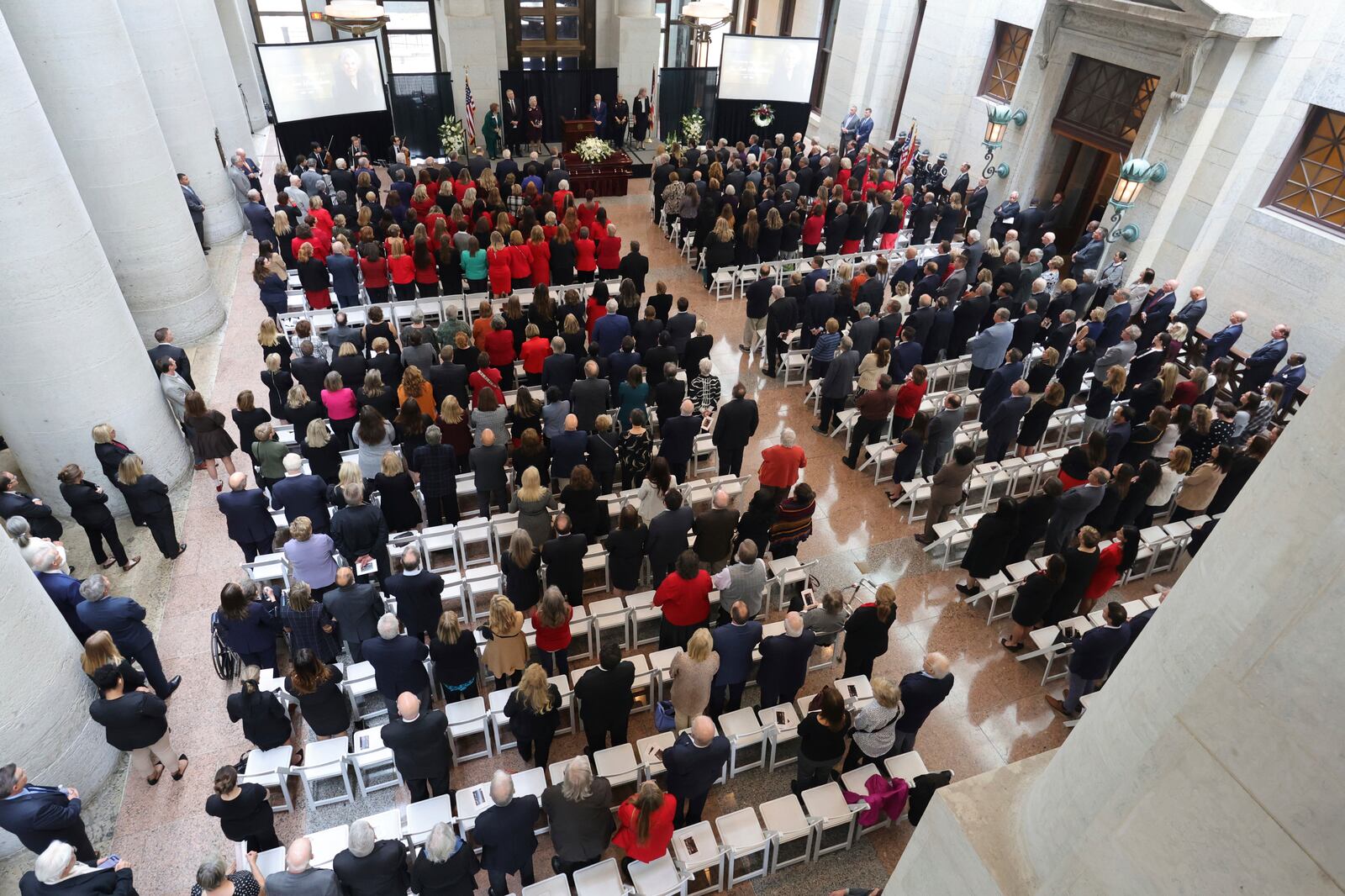 Mourners stand for the beginning of the funeral for former Ohio House speaker Jo Ann Davidson in the Atrium of the Ohio Statehouse in Columbus, Ohio, Thursday, Oct. 31, 2024. (AP Photo/Paul Vernon)