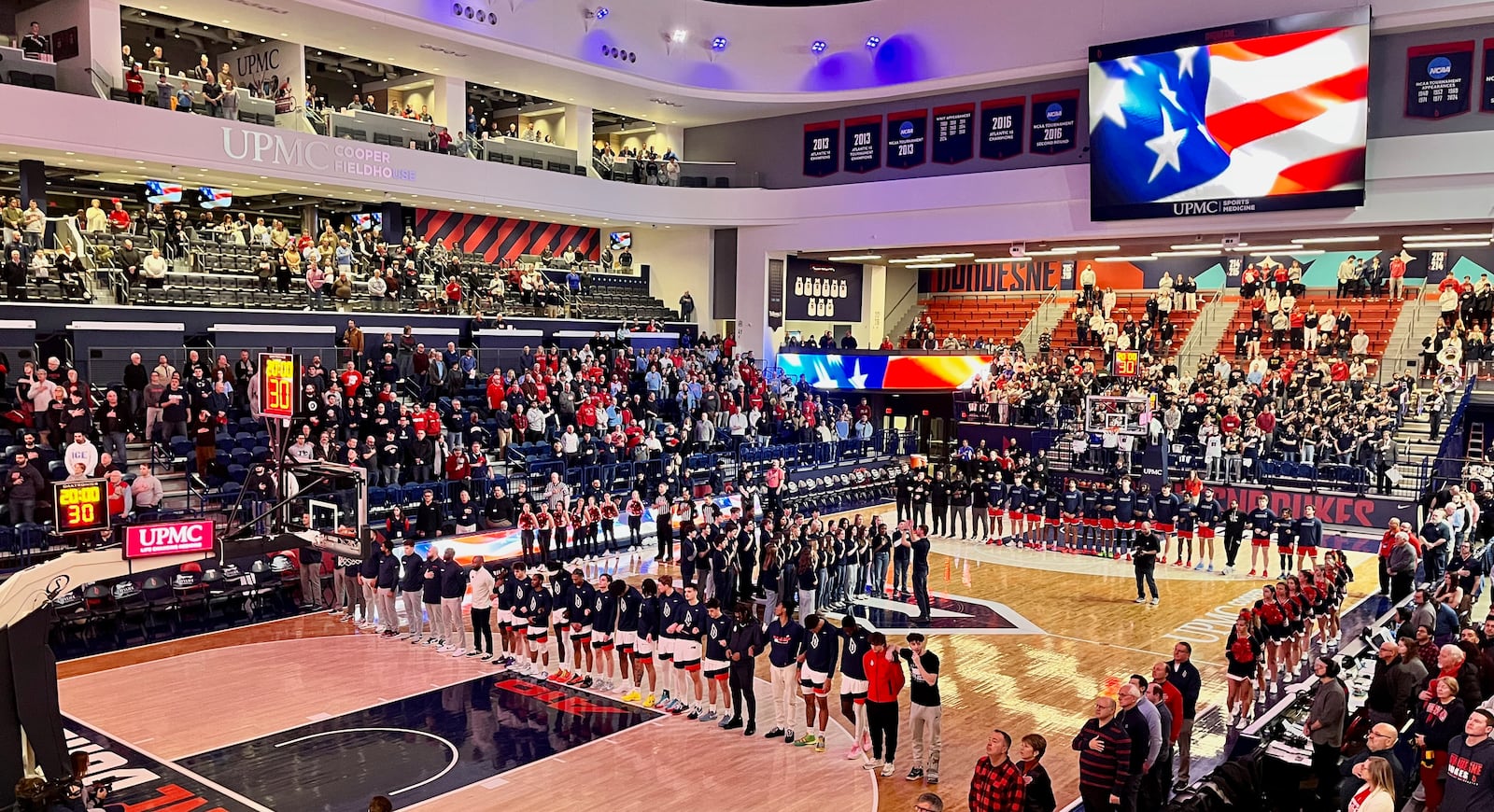 Dayton and Duquesne stand for the national anthem on Tuesday, Jan. 21, 2025, at the UPMC Cooper Fieldhouse in Pittsburgh. David Jablonski/Staff