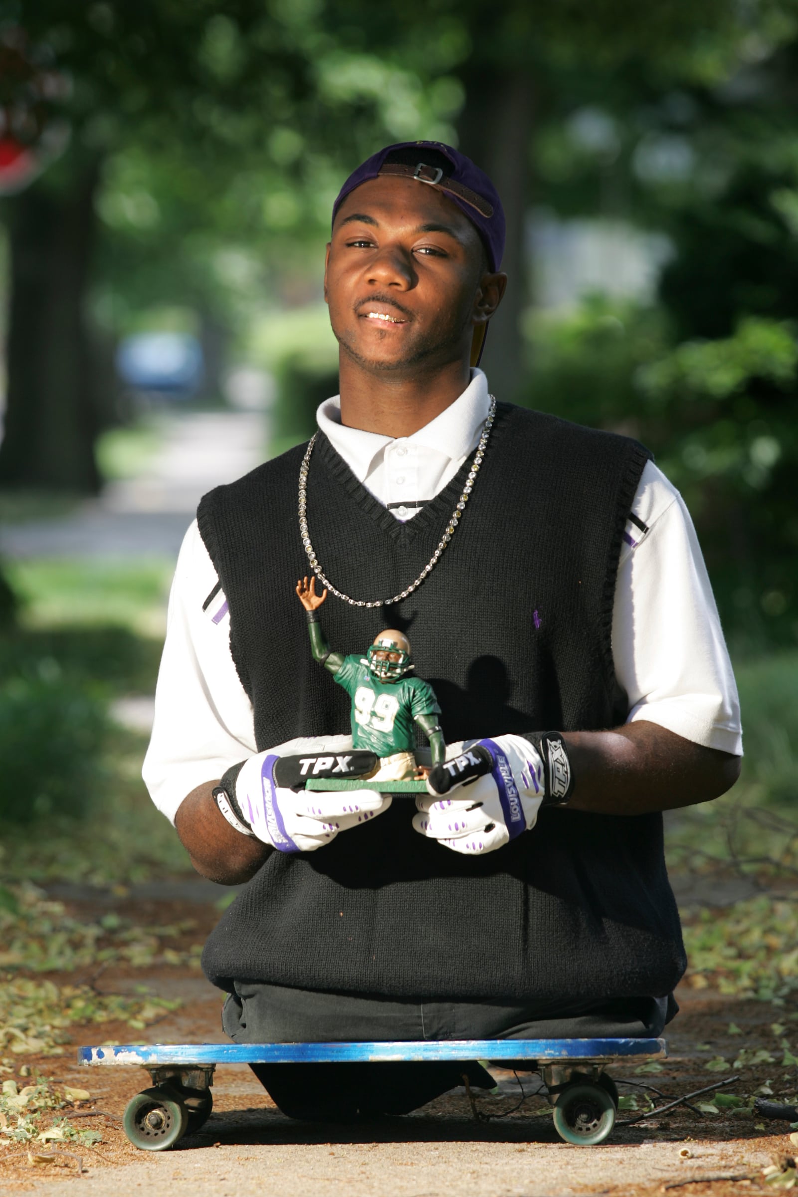 Colonel White graduate Bobby Martin hold an action figure of himself that a Canadian Toy Company custom made for him after reading his story by Tom Archdeacon. Martin has been nominated for an ESPY award. Photo by Jim Witmer