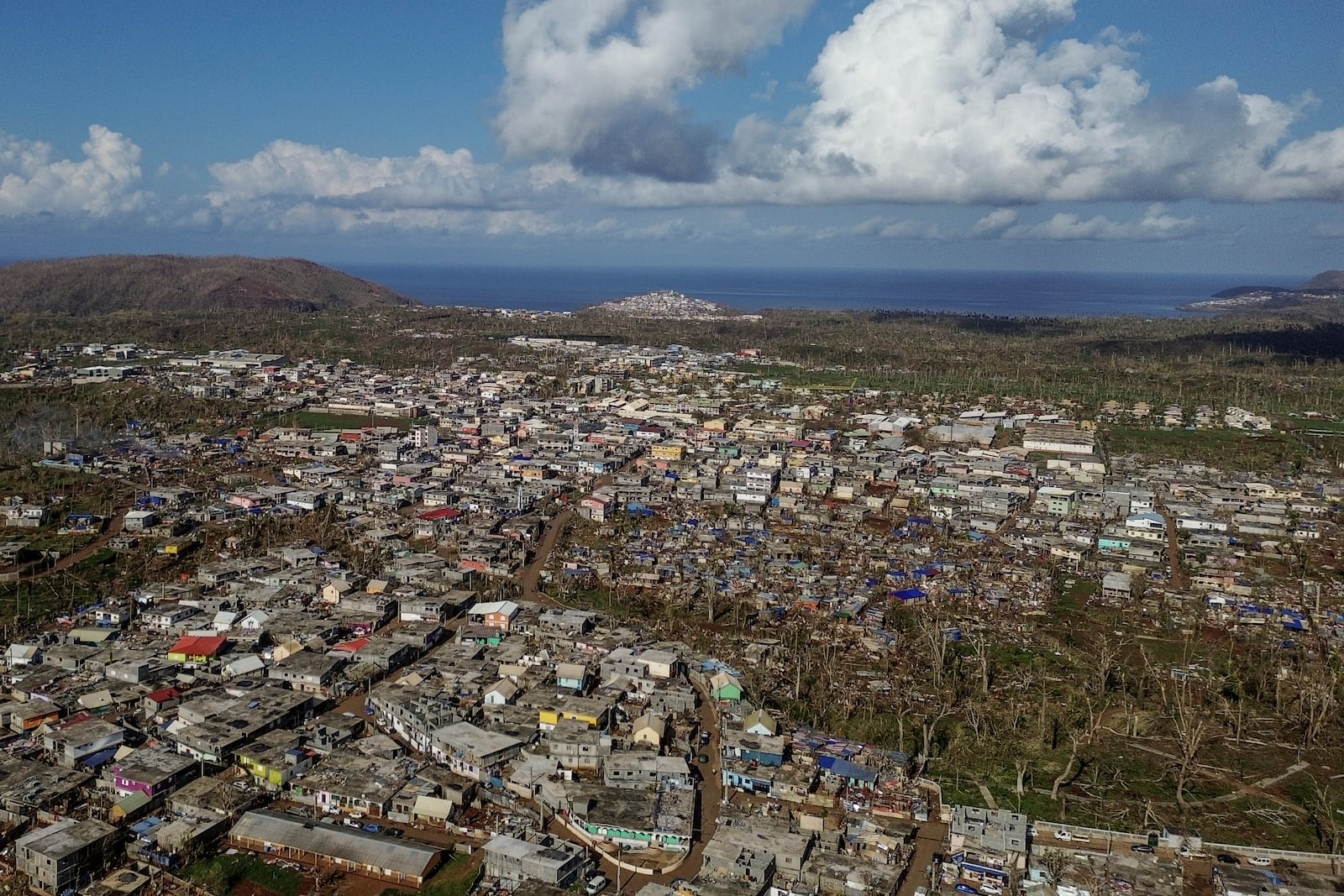 Drone view of destroyed dwellings in Mirereni, Mayotte, Friday, Dec. 20, 2024. (AP Photo/Adrienne Surprenant)