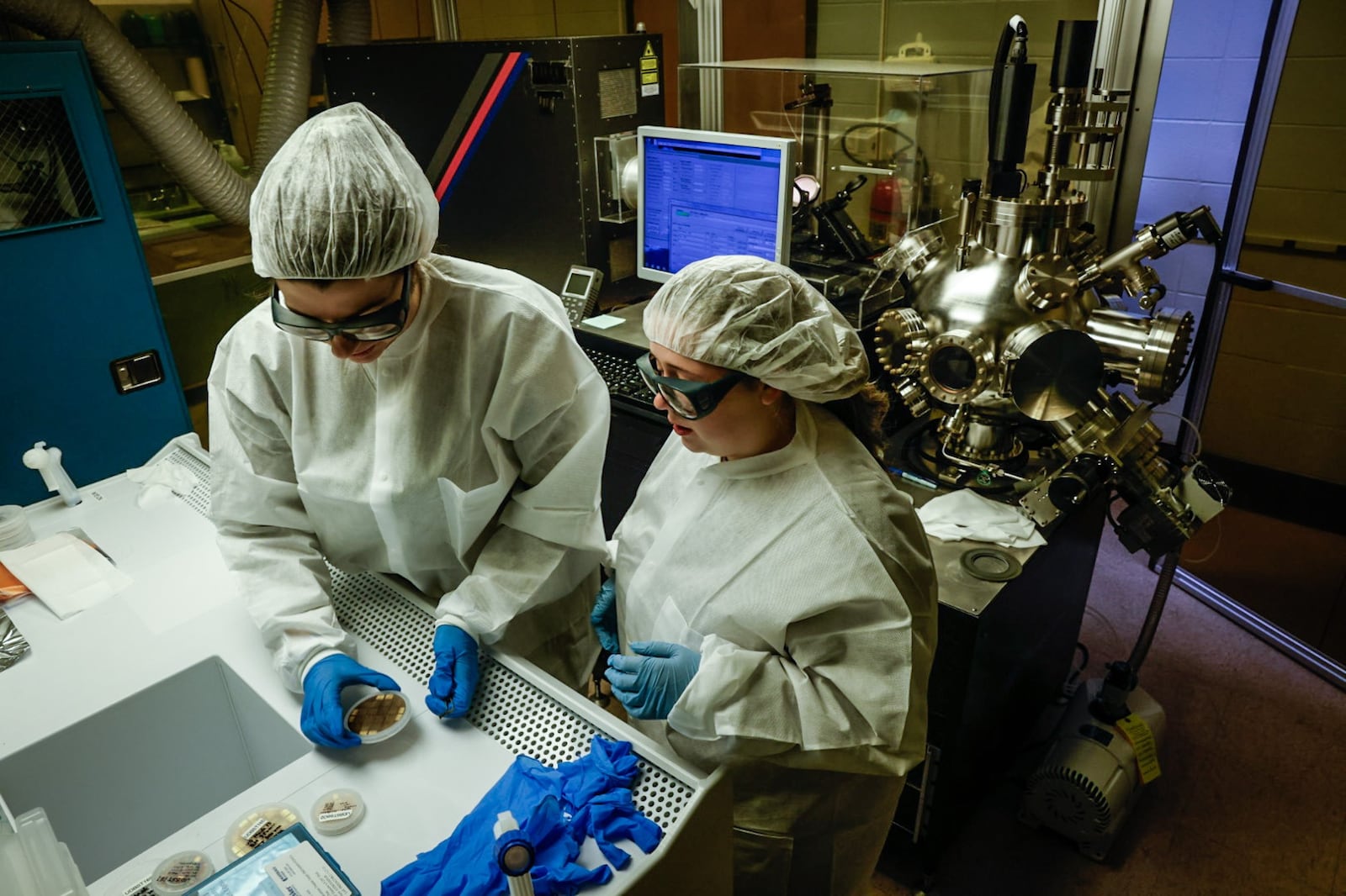 University of Dayton electrical engineering student Malia Hoffmire, left, and UD OASIS program participant Leah Dalton work in the Kettering Lab on the UD campus Monday April 22, 2024. The two women are making semiconductors. JIM NOELKER/STAFF