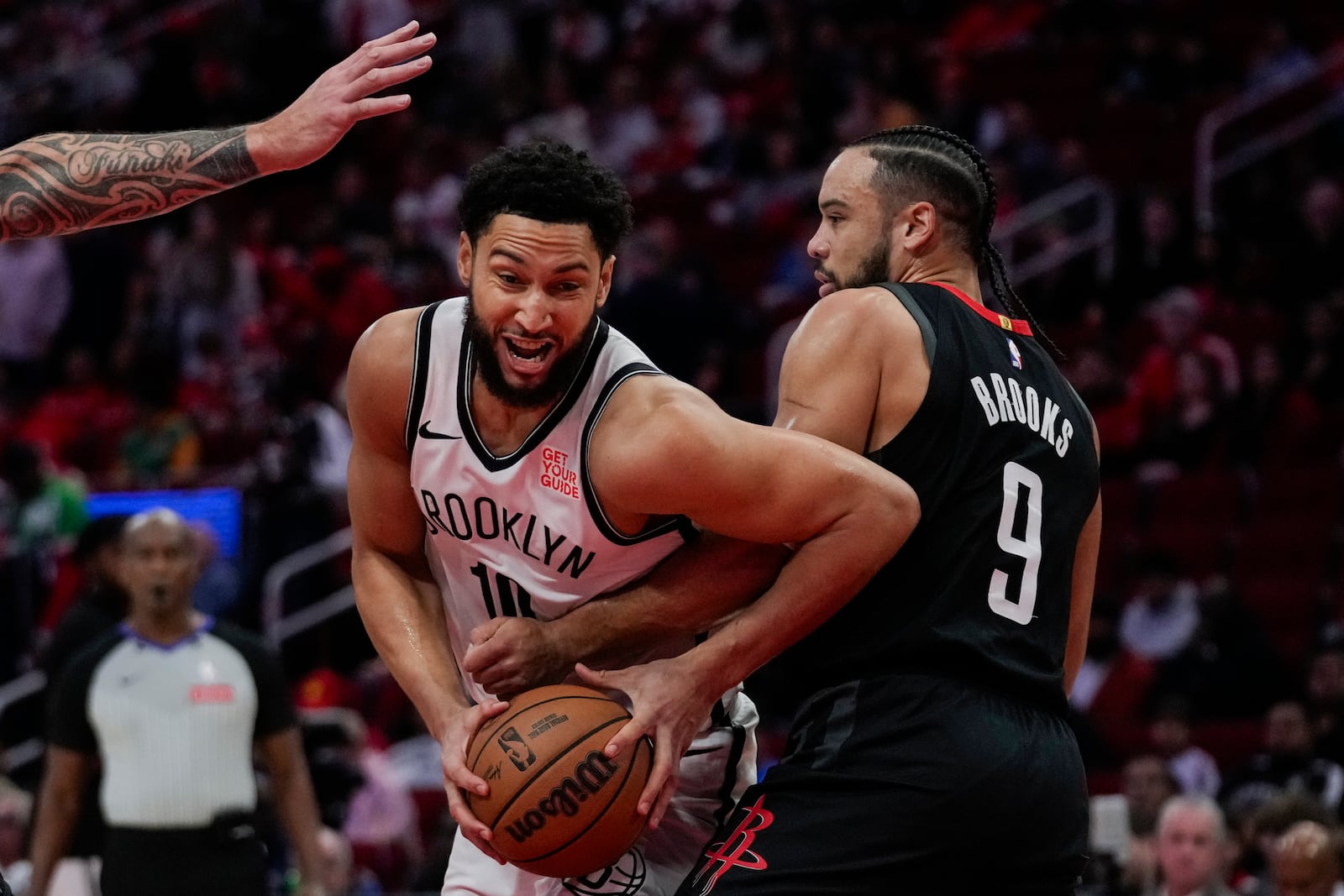 Houston Rockets forward Dillon Brooks (9) defends against Brooklyn Nets guard Ben Simmons (10) during the first half of an NBA basketball game in Houston, Saturday, Feb. 1, 2025. (AP Photo/Ashley Landis)