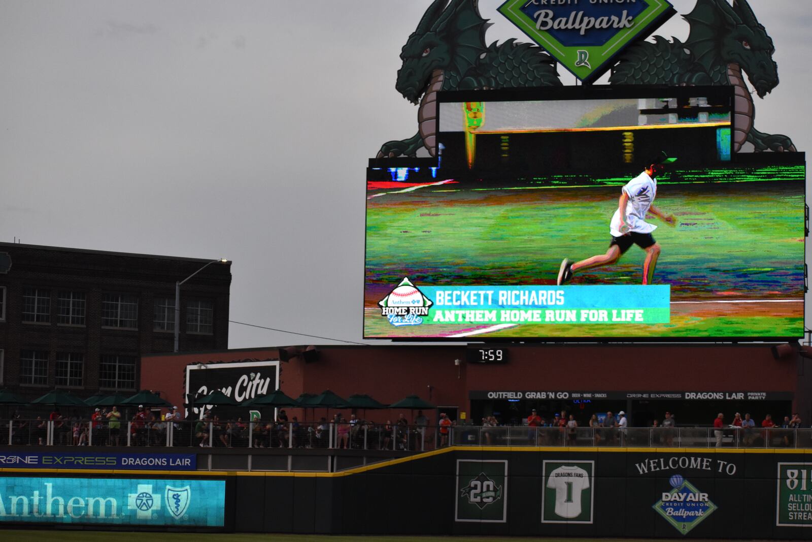 Local cancer survivor Beckett Richards, 8, on the jumbotron at a recent Dayton Dragons game as he runs the bases. SAMANTHA WILDOW\STAFF