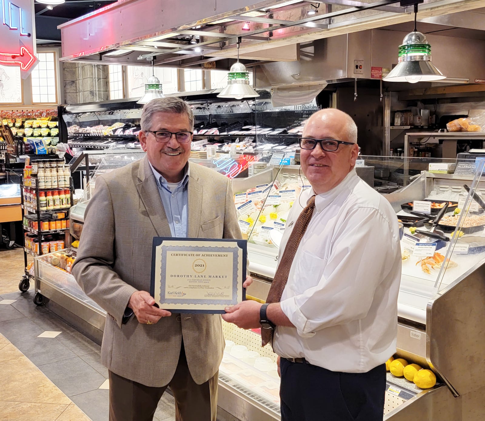 Montgomery County Auditor Karl Keith (left) presents store manager Jerry Post with a certificate at Dorothy Lane Market in Oakwood. CONTRIBUTED