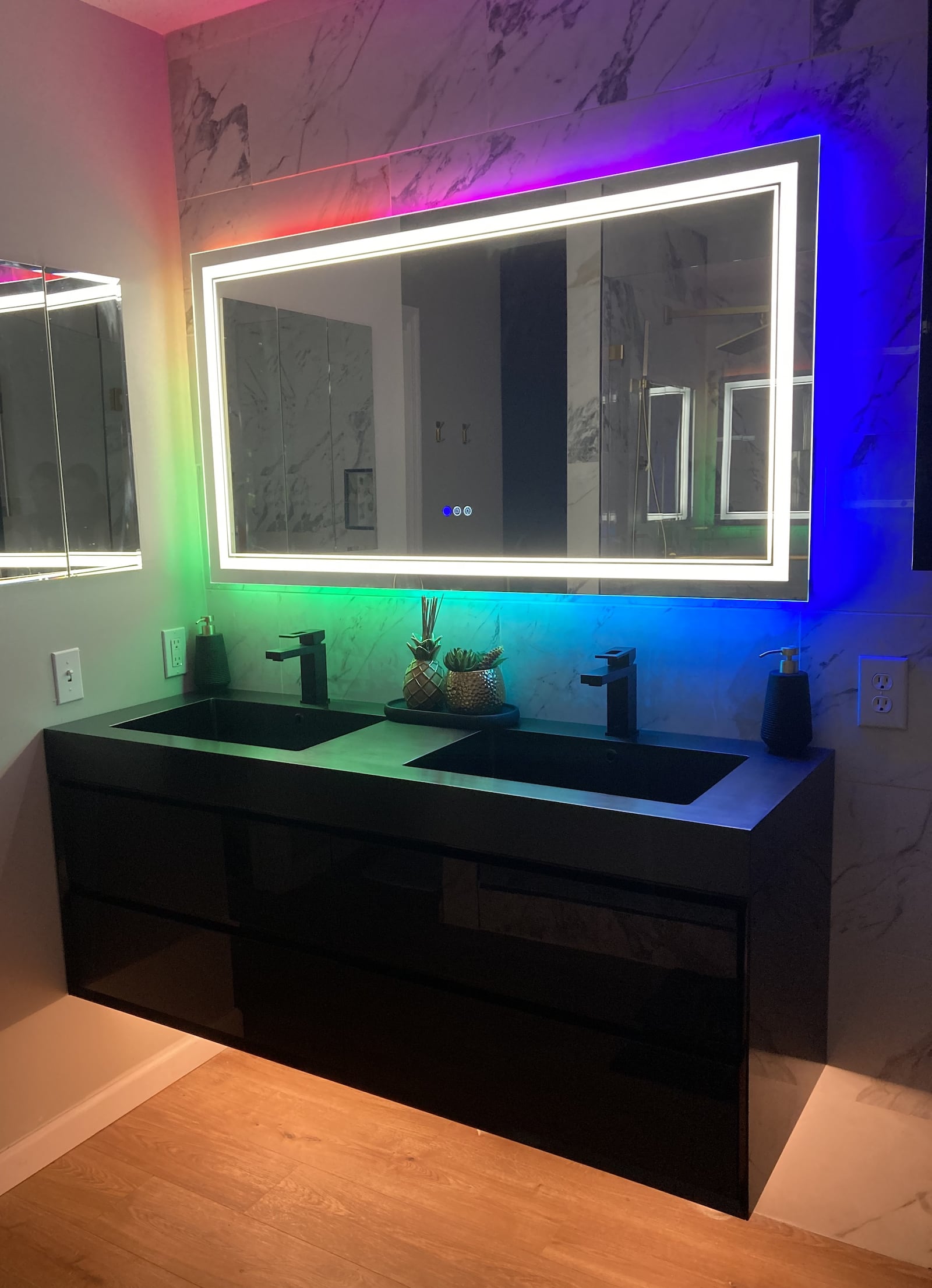 The floating dual-sink counter is topped with a defogging mirror that can display a range of colored lights. Contributed by Sarah Franks Fries