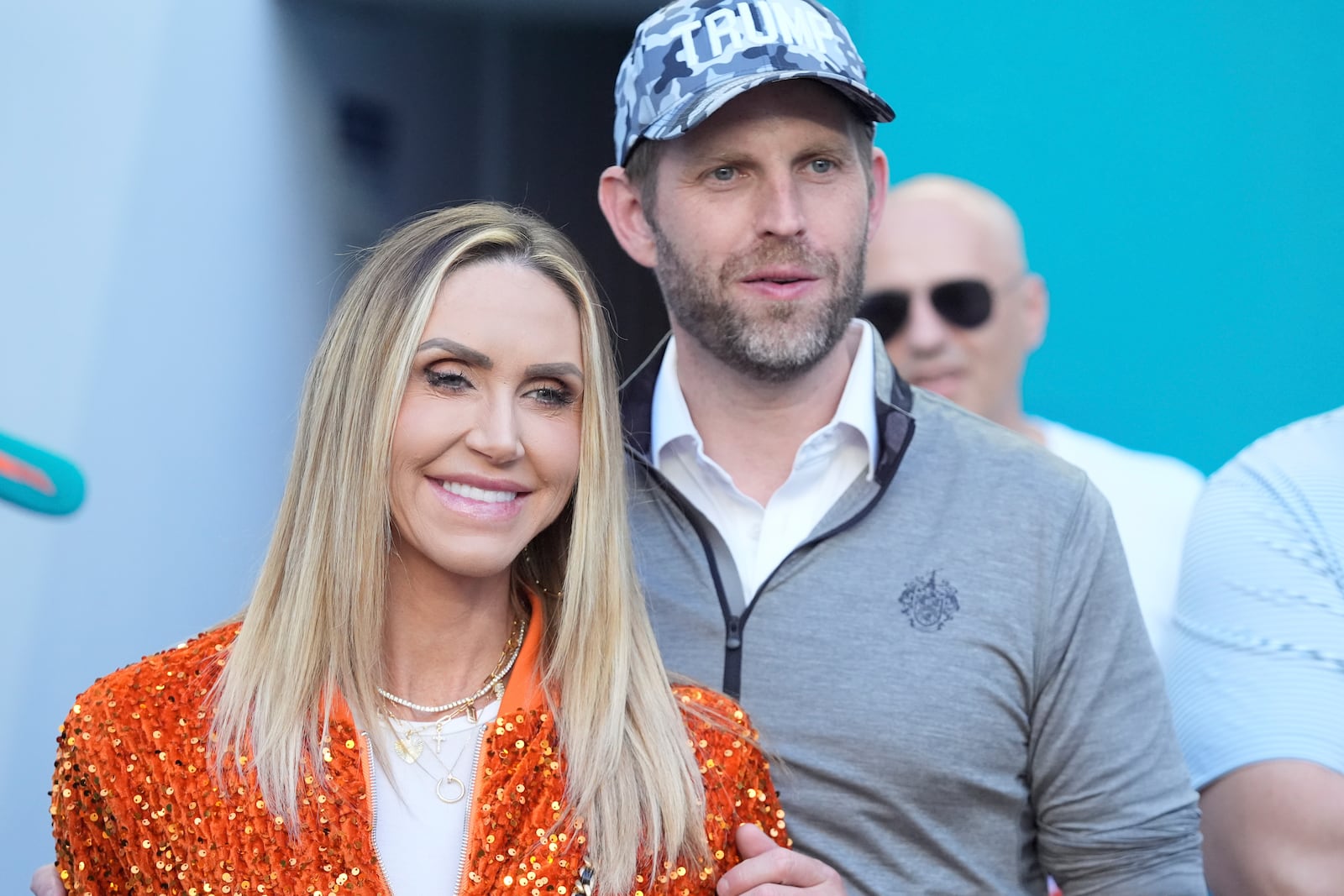 Eric and Lara Trump watch the second half of an NFL football game between the Miami Dolphins and the New England Patriots, Sunday, Nov. 24, 2024, in Miami Gardens, Fla. (AP Photo/Wilfredo Lee)