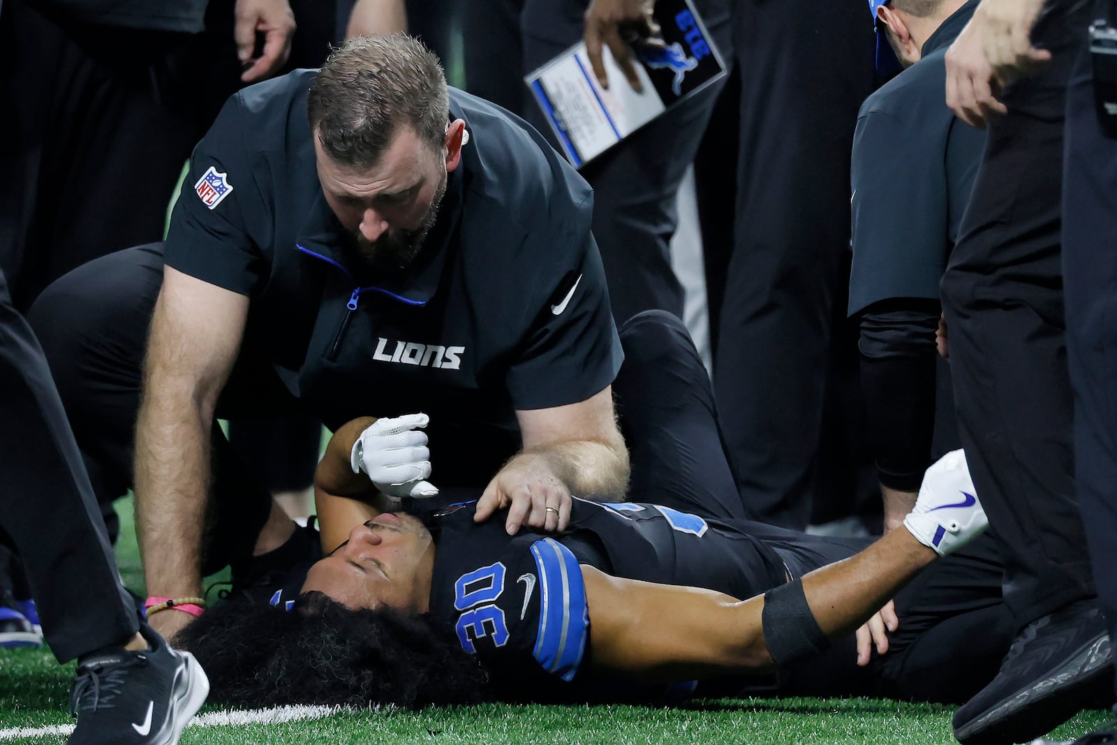 Trainers check on Detroit Lions cornerback Khalil Dorsey (30) during the first half of an NFL football game against the Buffalo Bills, Sunday, Dec. 15, 2024, in Detroit. (AP Photo/Duane Burleson)