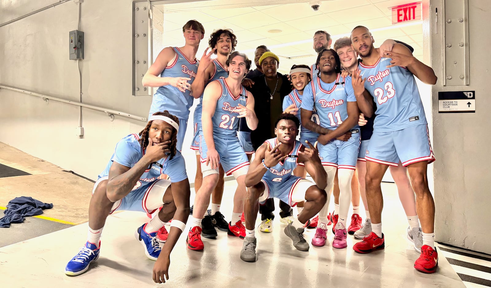 Comedian Dave Chappelle poses for a photo with Dayton players after a victory against Saint Louis on Tuesday, March 4, 2025, at UD Arena. Chappelle, a longtime Yellow Springs resident, visited UD Arena for the first time. David Jablonski/Staff