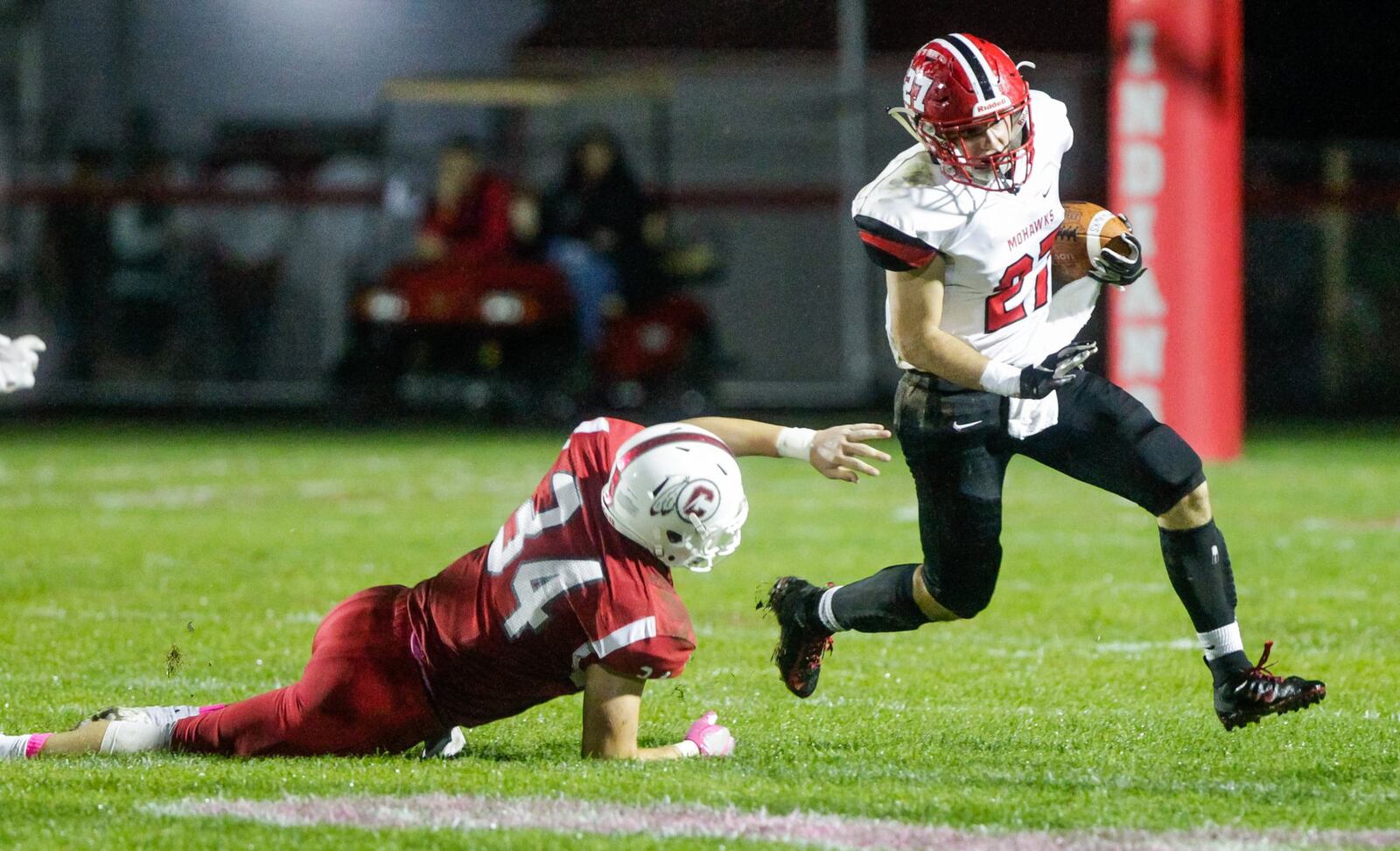 Madison’s Gabe Higgs carries the football defended by Carlisle’s Jayden Sweeney during their game Friday night, Oct. 11, 2019 at Laughlin Field in Carlisle. Madison won 26-16. NICK GRAHAM/STAFF