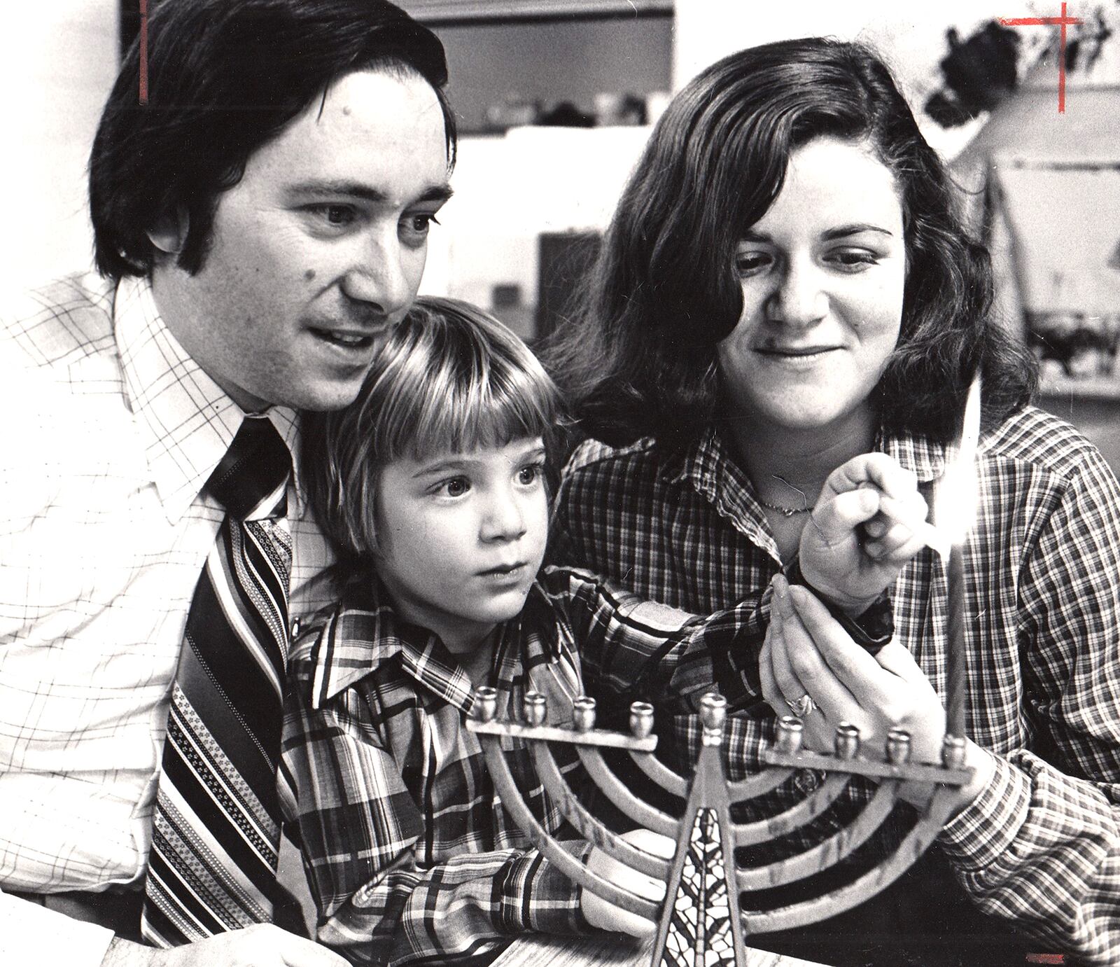 Mark and Roberta Weitz light the first candle on the menorah with their son Craig in 1979. DAYTON DAILY NEWS ARCHIVE