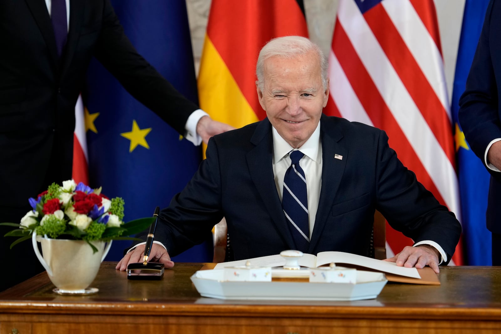 President Joe Biden signs a guest book during the welcoming ceremony at Bellevue Palace in Berlin, Germany, Friday, Oct. 18, 2024. (AP Photo/Ben Curtis)