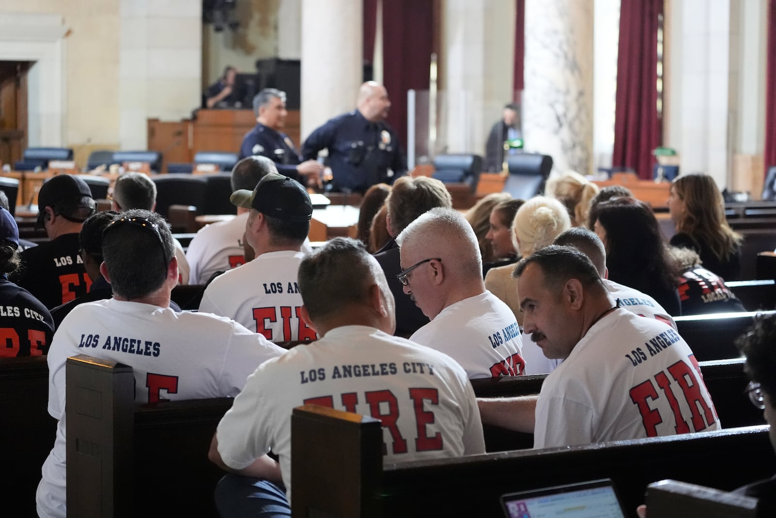 Firefighters attend a city council meeting to support ousted fire chief Kristin Crowley, Tuesday, March 4, 2025, in Los Angeles. (AP Photo/Damian Dovarganes)