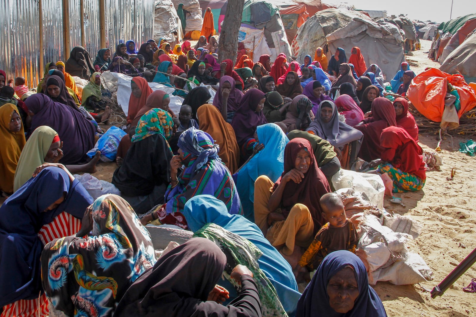 FILE - Somalis who fled drought-stricken areas sit at a makeshift camp on the outskirts of the capital Mogadishu, Somalia on Feb. 4, 2022. (AP Photo/Farah Abdi Warsameh, File)