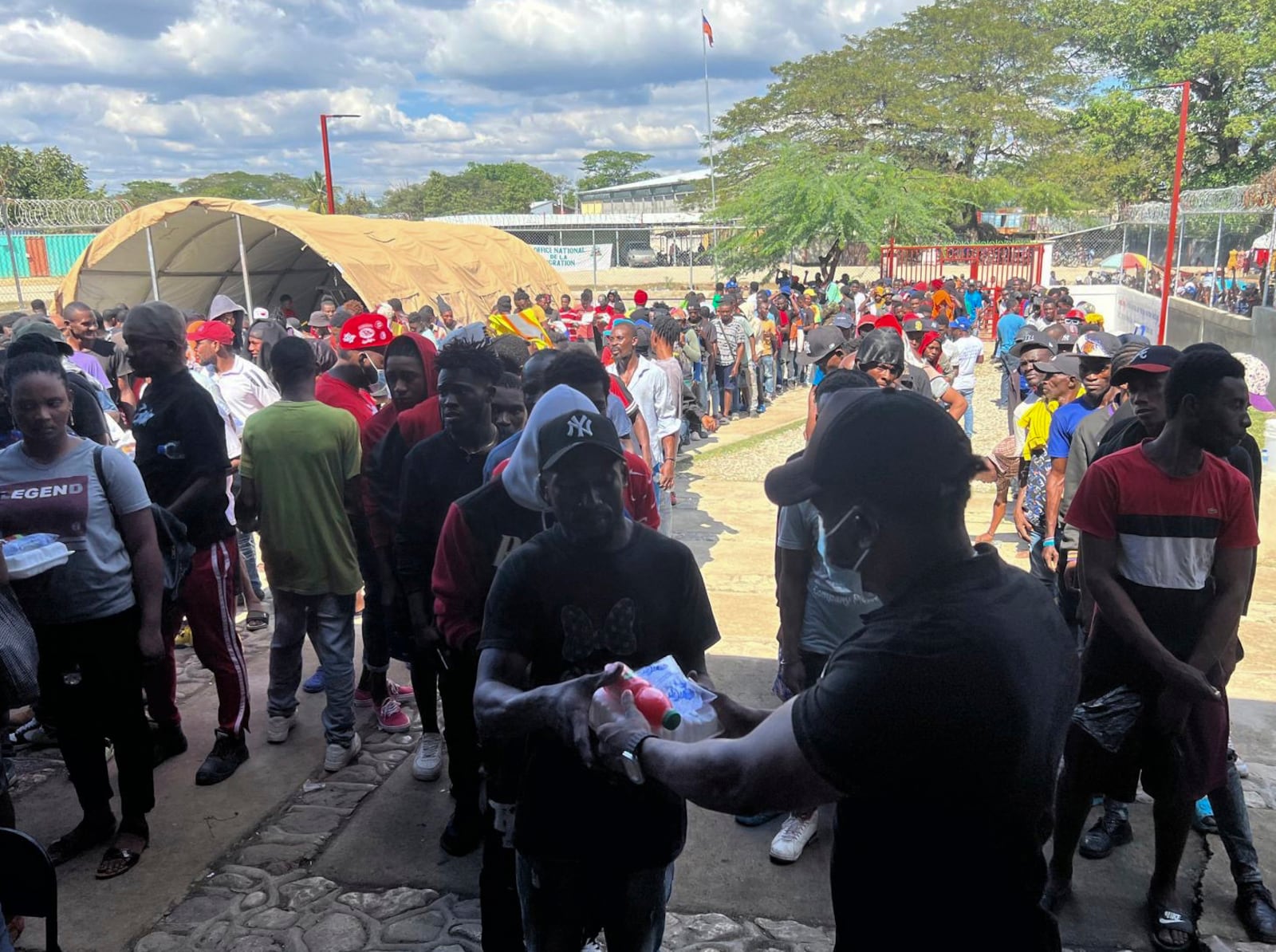 Haitians line up at a non-profit help center to receive food after being deported from the Dominican Republic, in Belladere, Haiti, Thursday, Jan. 30, 2025. (AP Photo/Danica Coto)