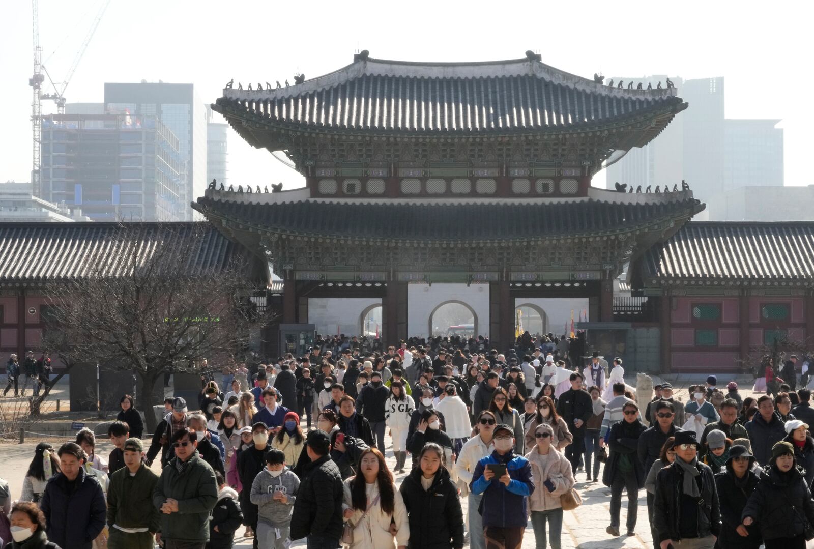 FILE - People visit the Gyeongbok Palace, the main royal palace during the Joseon Dynasty and one of South Korea's well known landmarks, during Lunar New Year holiday celebrations in Seoul, South Korea, Feb. 12, 2024. (AP Photo/Ahn Young-joon, File)