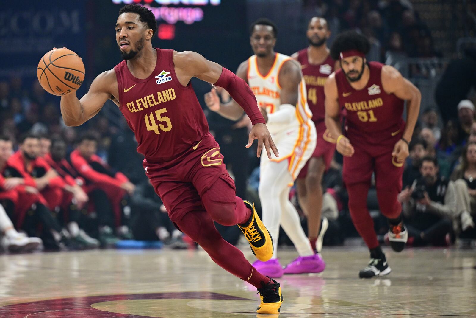 Cleveland Cavaliers guard Donovan Mitchell (45) dribbles against the Atlanta Hawks during an NBA basketball game Thursday, Jan. 30, 2025, in Cleveland. (AP Photo/David Dermer)