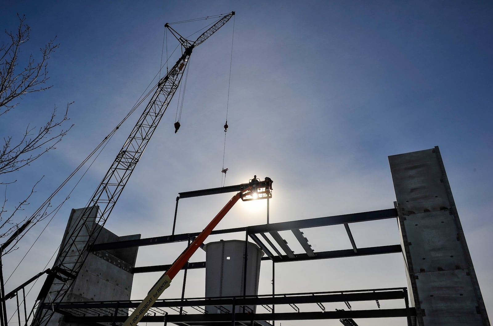 Crews from Megen Construction puts one of the tallest beams on the structure at iFLY Cincinnati Tuesday, Jan. 22 at the Liberty Center shopping complex in Liberty Township. The more than 51,000 square foot indoor skydiving facility is expected to open this spring. NICK GRAHAM/STAFF