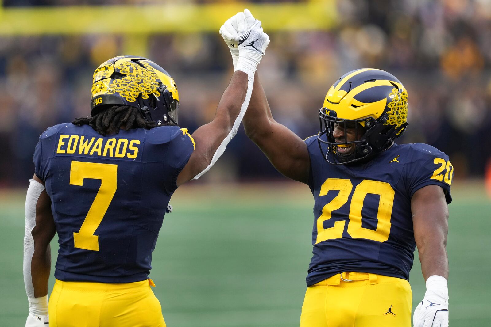 Michigan running back Kalel Mullings (20) celebrates his two-yard touchdown run with Donovan Edwards (7) in the first half of an NCAA college football game against Northwestern in Ann Arbor, Mich., Saturday, Nov. 23, 2024. (AP Photo/Paul Sancya)