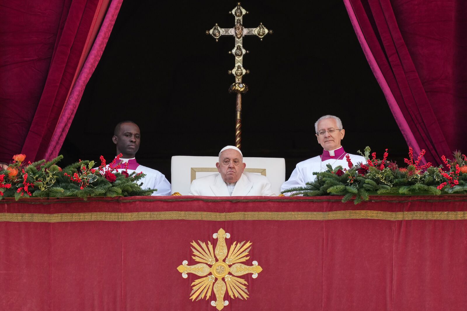 Pope Francis sits before delivering the Urbi et Orbi (Latin for 'to the city and to the world' ) Christmas' day blessing from the main balcony of St. Peter's Basilica at the Vatican, Wednesday, Dec. 25, 2024. (AP Photo/Andrew Medichini)