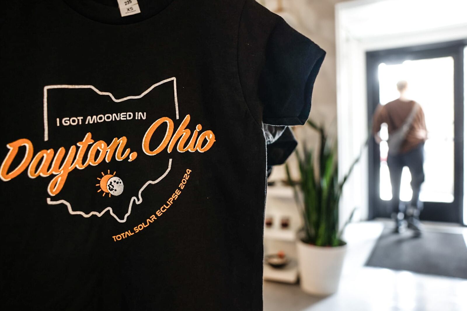 This Dayton solar eclipse shirt is sold at Heart Mercantile on East 5th Street in the Oregon District. JIM NOELKER/STAFF