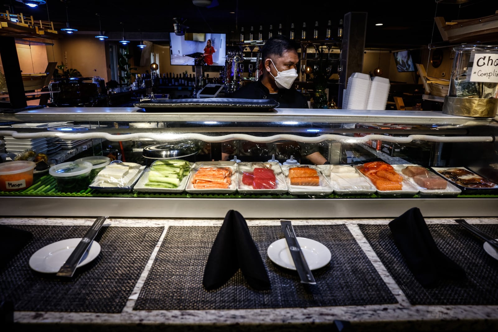 Thai Table Sushi Chief, Art Sabsombat readies food at the restaurant Monday March 14, 2022. Two years ago, Ohio shut down bars and indoor dining for two-and -a-half months in hopes of stopping the spread of COVID-19. JIM NOELKER/STAFF