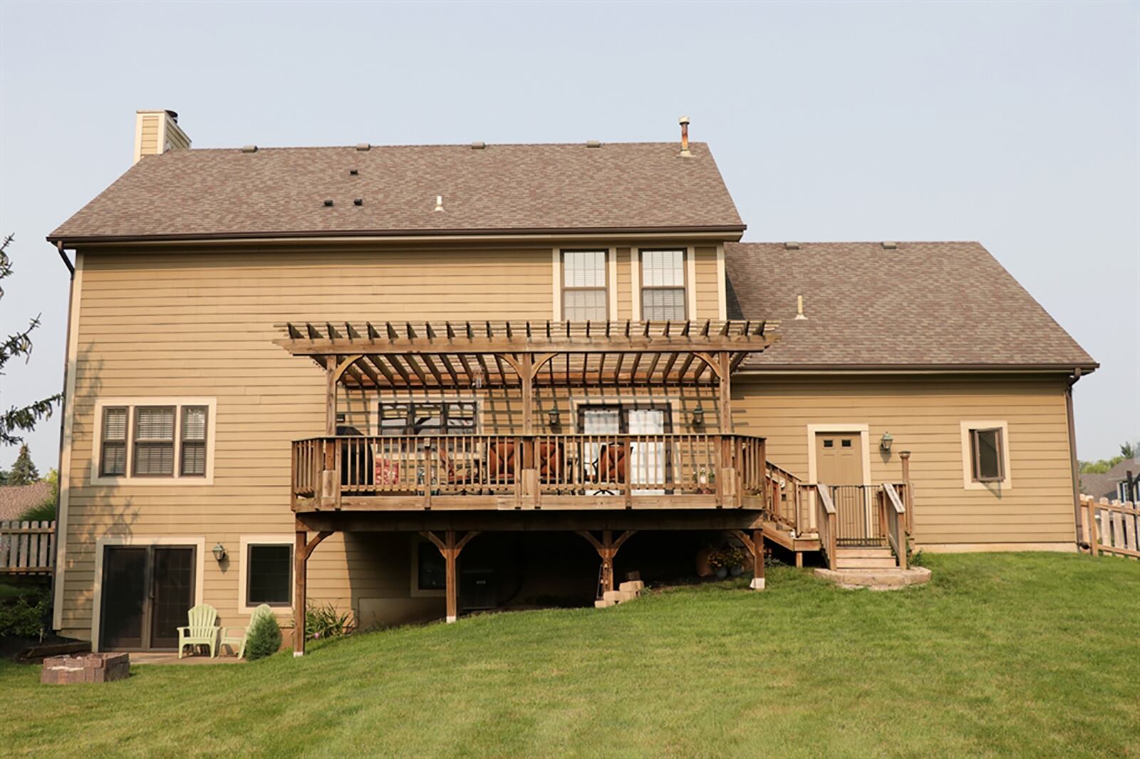 Patio doors with built-in blinds open from the breakfast room to the multi-level wooden deck. Most of the deck is covered by a pergola. CONTRIBUTED PHOTO BY KATHY TYLER