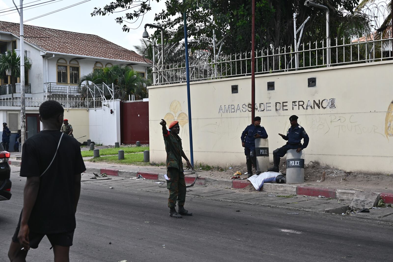 Congolese security personnel stand in front of the French Embassy in Kinshasa, Democratic Republic of the Congo Tuesday, Jan. 28, 2025, after it was attacked by demonstrators protesting the Rwanda-backed M23 rebels' advances into eastern Congo's capital Goma. (AP Photo/Samy Ntumba Shambuyi)