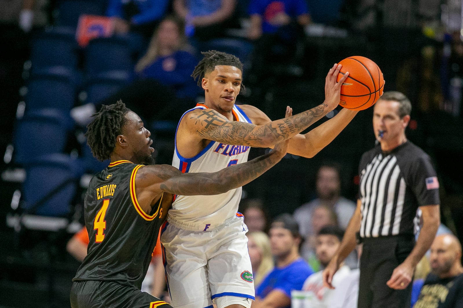 Grambling State guard P.J. Edwards (4) pressures Florida guard Will Richard, right, during the first half of an NCAA college basketball game, Monday, Nov. 11, 2024, in Gainesville, Fla. (AP Photo/Alan Youngblood)