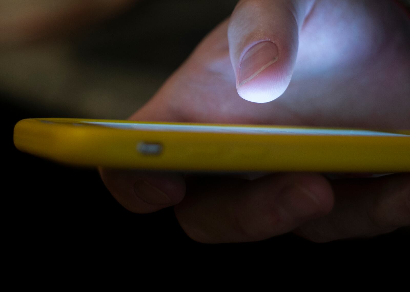 In this Sunday, Aug. 11, 2019, photo, a man uses a cell phone in New Orleans. Quick help for suicidal thoughts and other mental health emergencies may soon be as easy as 9-8-8. The United States’ first nationwide three-digit mental health crisis hotline goes live on Saturday, July 16, 2022. (AP Photo/Jenny Kane, File)