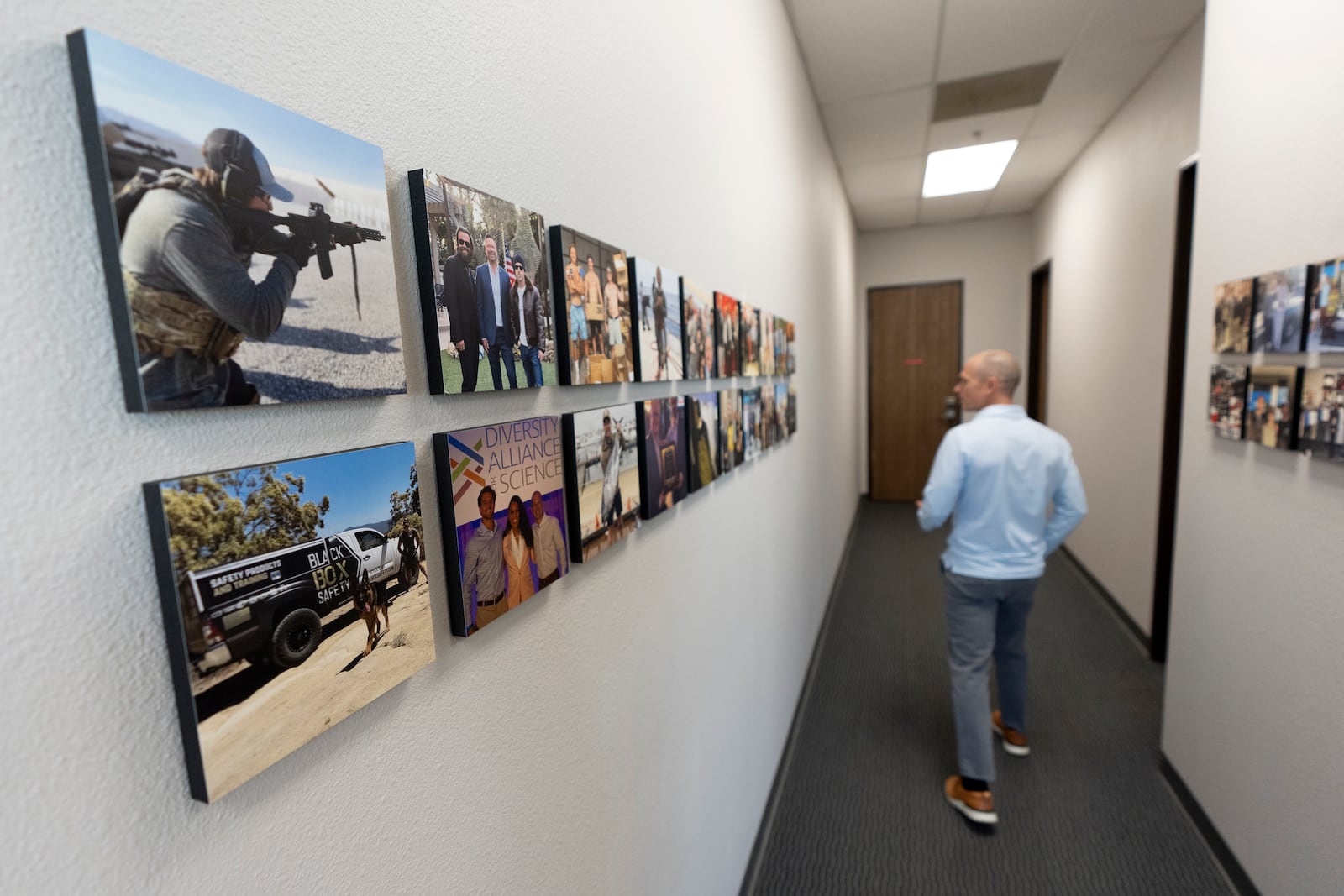 Veteran and business owner Jackson Dalton walks along a hallway at the Black Box Safety offices, Thursday, Nov. 7, 2024, in El Cajon, Calif. (AP Photo/Gregory Bull)