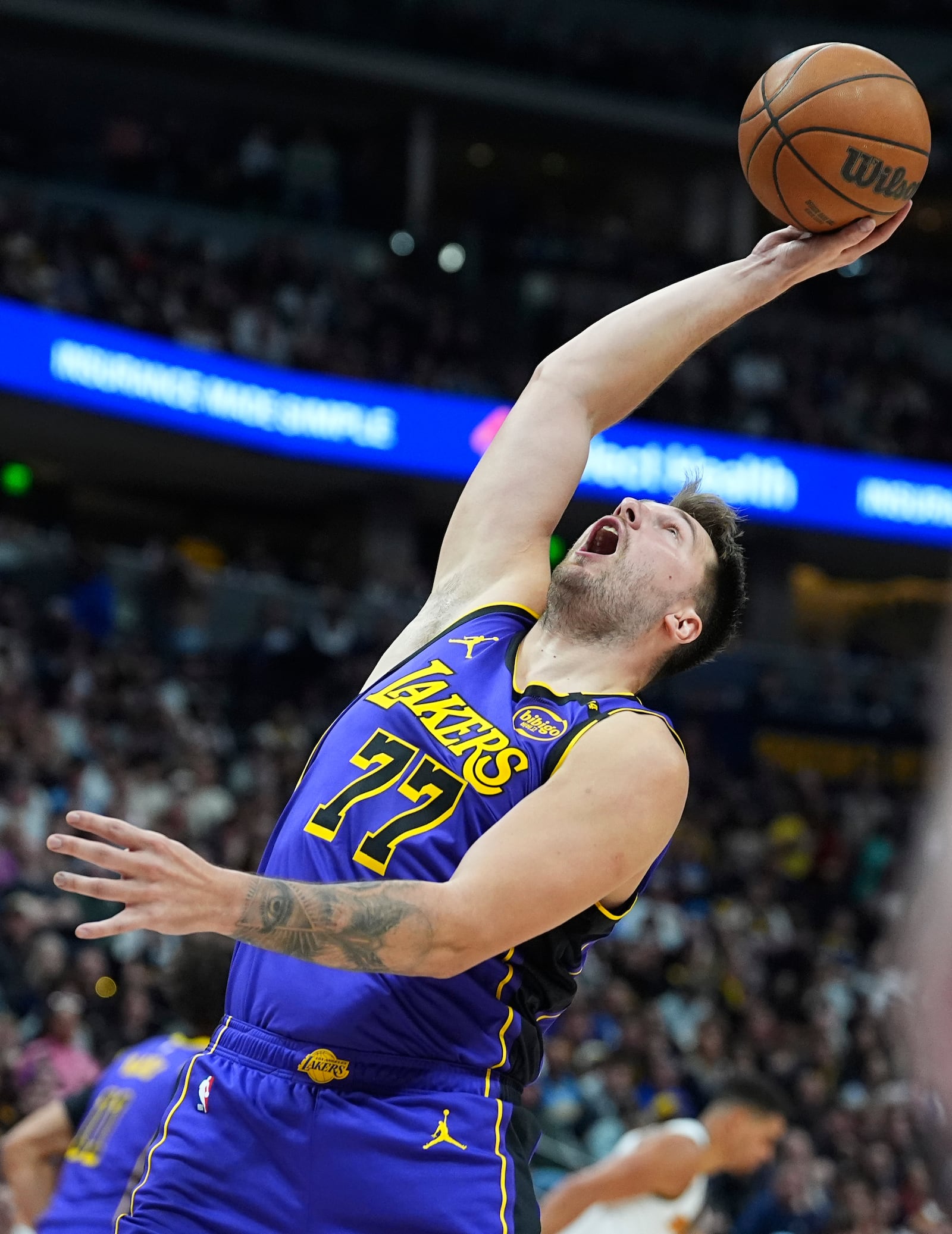 Los Angeles Lakers guard Luka Doncic pulls in a rebound in the second half of an NBA basketball game against the Denver Nuggets, Saturday, Feb. 22, 2025, in Denver. (AP Photo/David Zalubowski)