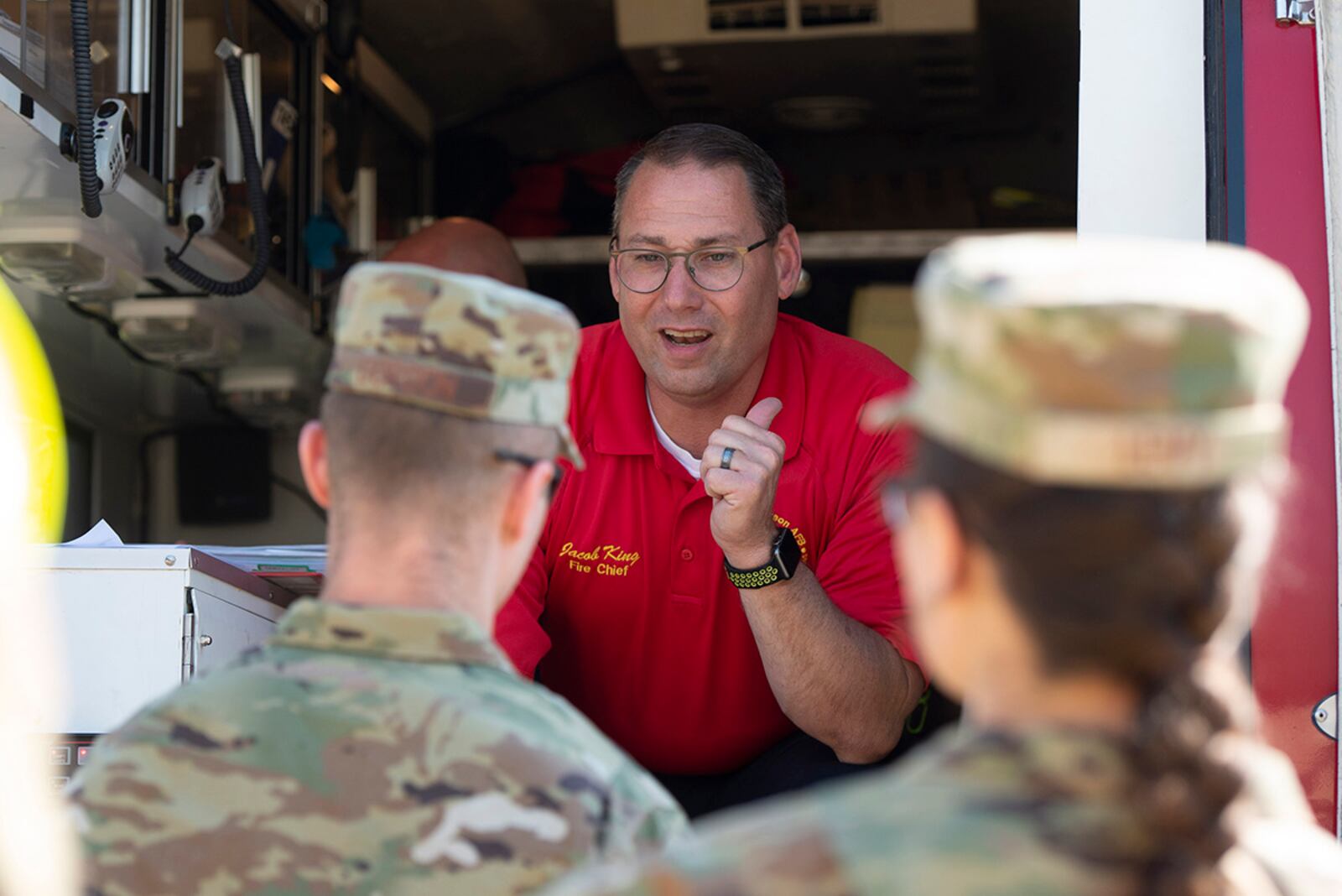 Jacob King, 788th Civil Engineer Squadron fire chief, talks with members of the 88th Medical Group’s Bioenvironmental Engineering Office during a “fuel spill” exercise at Wright-Patterson Air Force Base on May 19.  U.S. AIR FORCE PHOTO/WESLEY FARNSWORTH