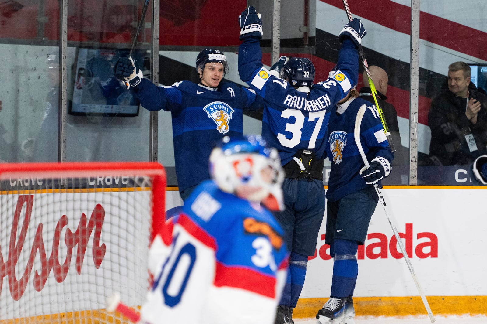 Finland forward Rasmus Kumpulainen (18) celebrates his goal with teammates Benjamin Rautianen (37) and Konsta Helenius (19) during the second period of an IIHF World Junior Hockey Championship quarterfinal match in Ottawa, Ontario Thursday, Jan. 2, 2025. (Spencer Colby/The Canadian Press via AP)