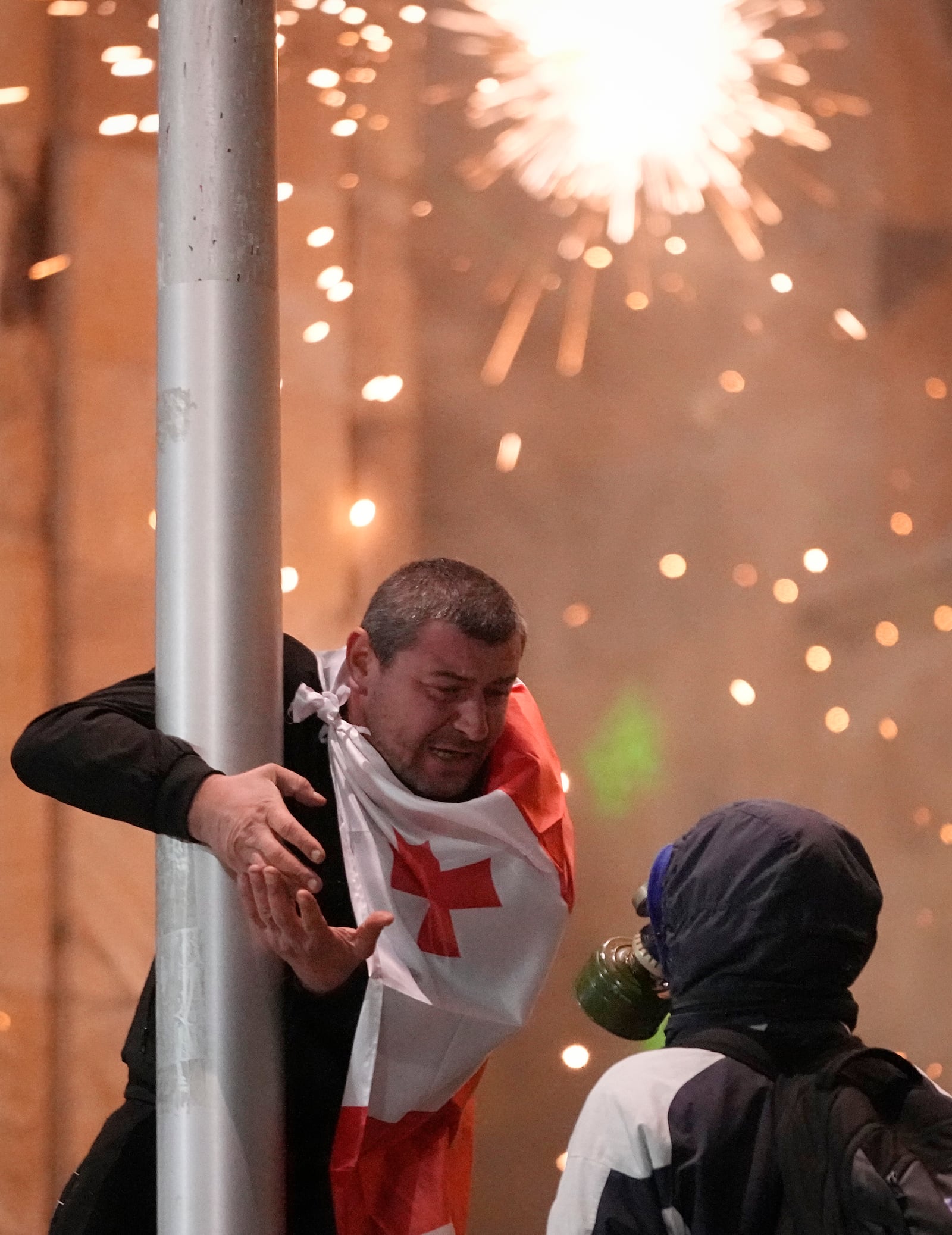 Demonstrators talk during a protest outside the parliament against the government's decision to suspend negotiations on joining the European Union in Tbilisi, Georgia, on Tuesday, Dec. 3, 2024. (AP Photo/Pavel Bednyakov)