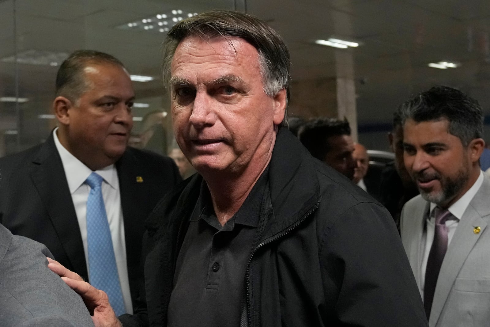 Former Brazilian President Jair Bolsonaro arrives for a luncheon with senators from his support base, at the National Congress building in Brasilia, Brazil, Tuesday, Feb. 18, 2025. (AP Photo/Eraldo Peres)