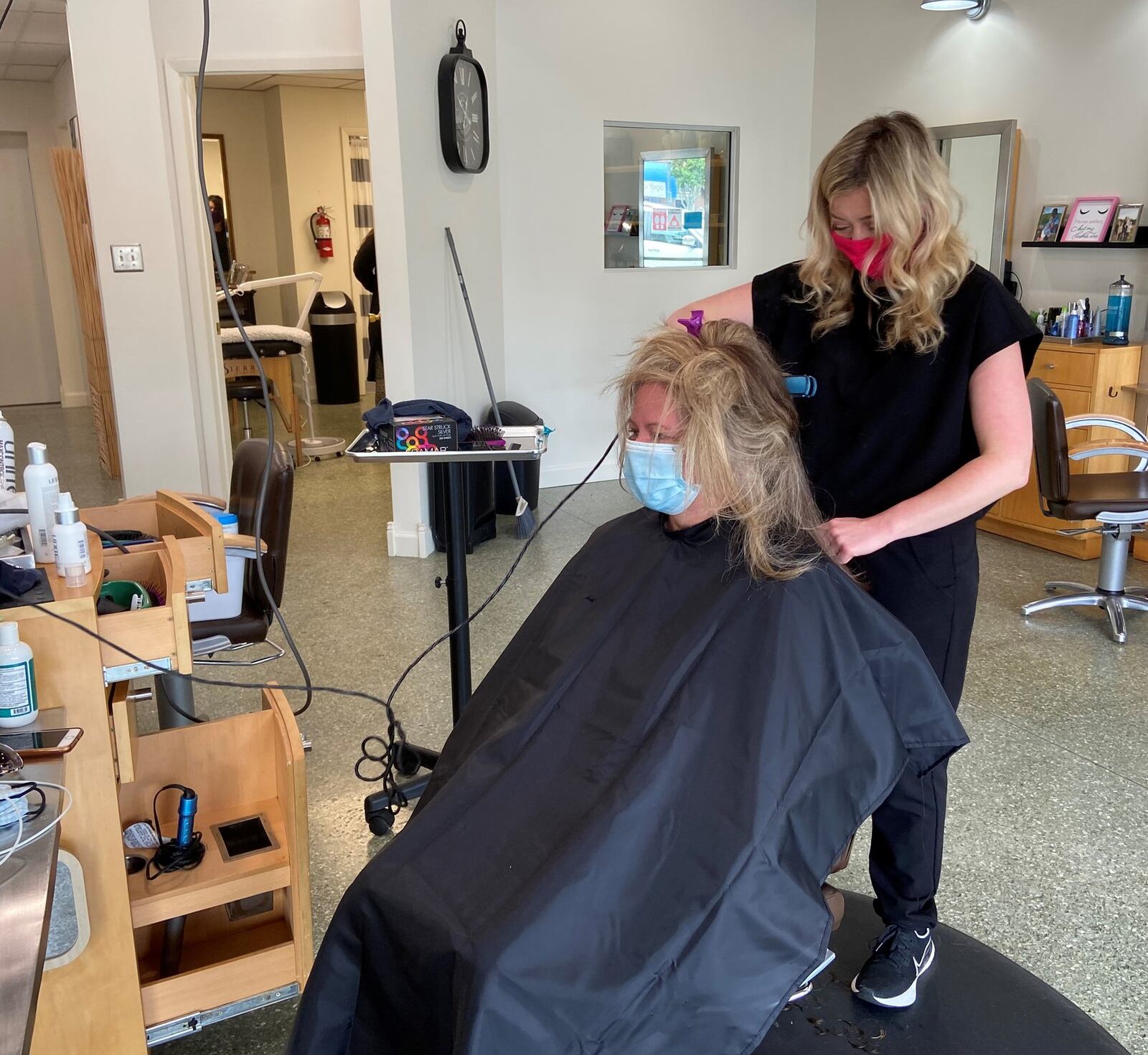 Emily Young styles customer Morgan Arwood’s hair at Bentley’s Salon in Fairborn on Friday. It was the first time in two months that salons and barbershops were allowed to open as part of the next phase of the governor s gradual re-opening of nonessential businesses.