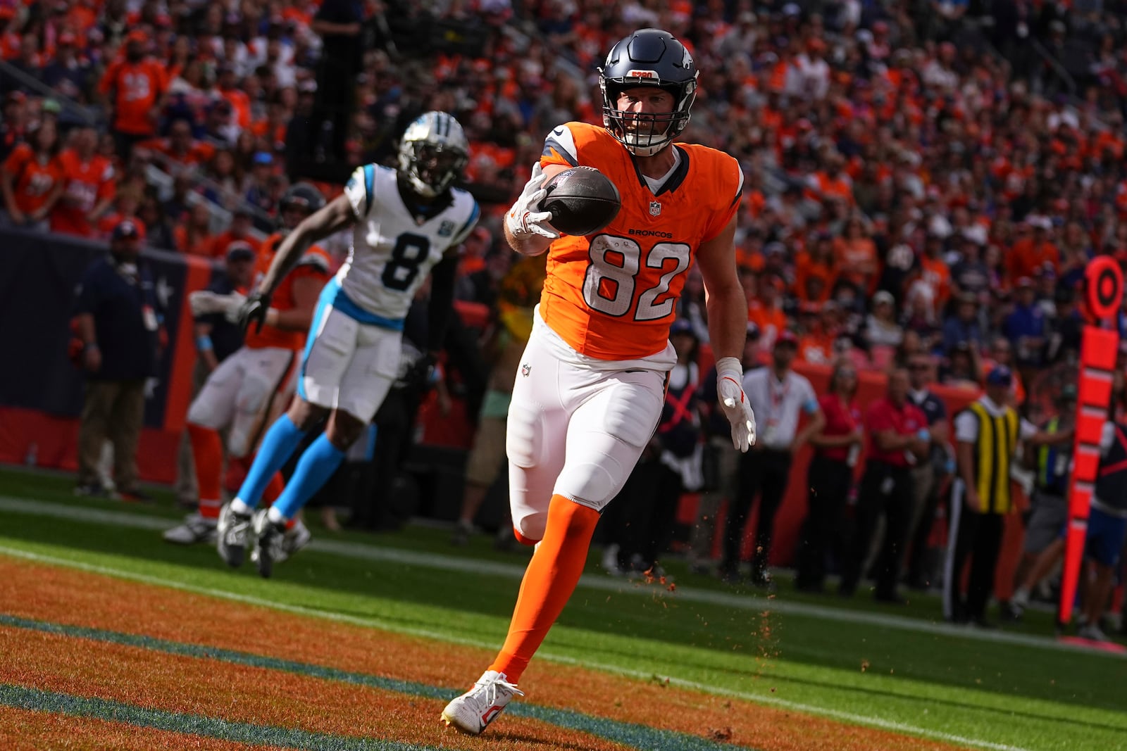 Denver Broncos tight end Adam Trautman (82) catches a pass for a touchdown against the Carolina Panthers during the first half of an NFL football game Sunday, Oct. 27, 2024, in Denver. (AP Photo/Bart Young)