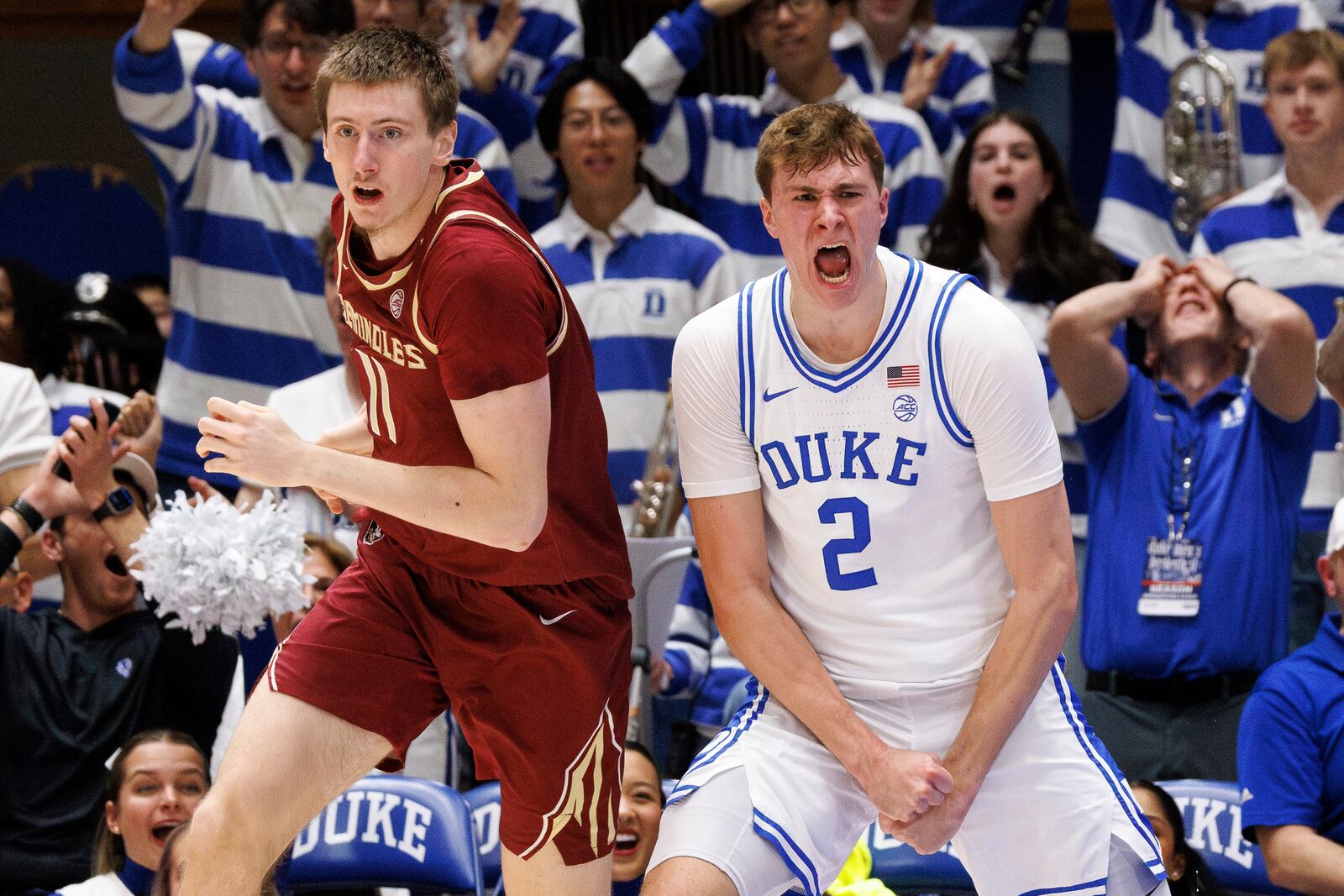 Duke's Cooper Flagg (2) reacts ahead of Florida State's Christian Nitu (11) after blocking Nitu's shot in the second half of an NCAA college basketball game in Durham, N.C., Saturday, March 1, 2025. (AP Photo/Ben McKeown)