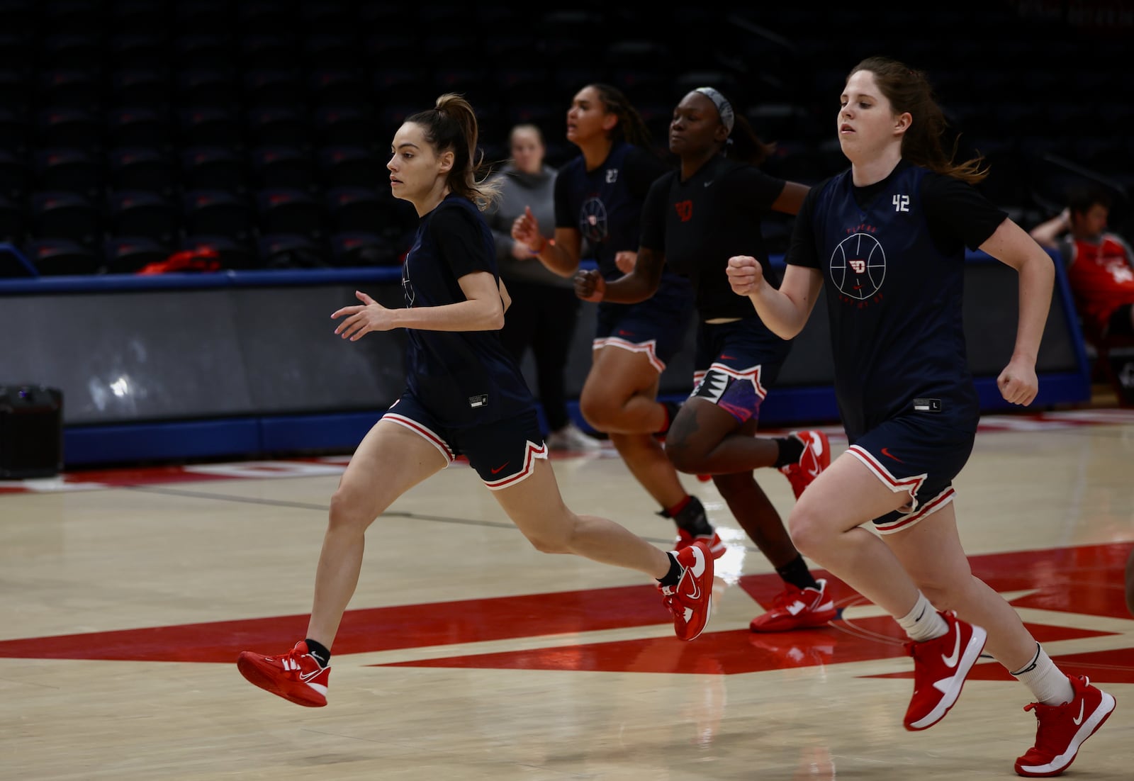 Dayton's Sydney Freeman, left, runs during practice on Tuesday, Oct. 4, 2022, at UD Arena. David Jablonski/Staff