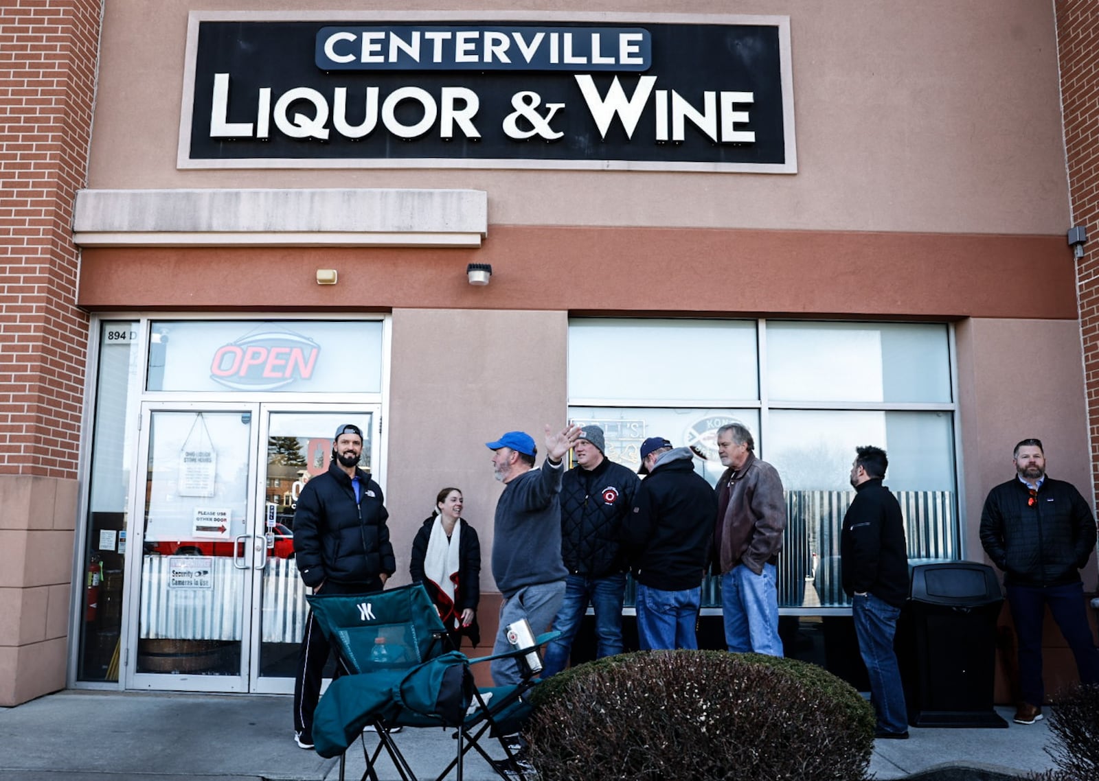 Customers wait in the cold to buy limited allocated bourbon at Centerville Liquor & Wine on South Main Street in Centerville Friday, Feb. 24, 2023. Total sales revenue from liquor increased in Ohio in 2022 by nearly 1%, while the amount of gallons sold decreased by nearly 1.8%. JIM NOELKER/STAFF