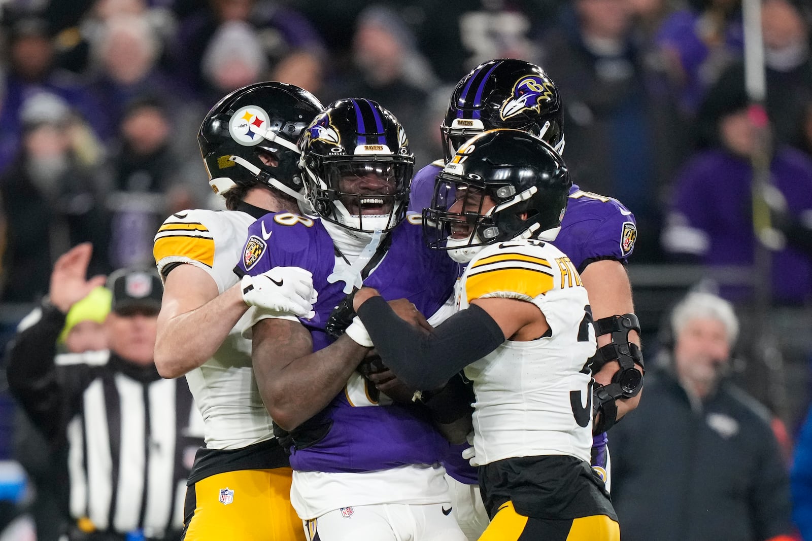 Baltimore Ravens quarterback Lamar Jackson, center, reacts after being stopped by Pittsburgh Steelers safety Minkah Fitzpatrick, right, during the first half of an NFL wild-card playoff football game, Saturday, Jan. 11, 2025, in Baltimore. (AP Photo/Stephanie Scarbrough)