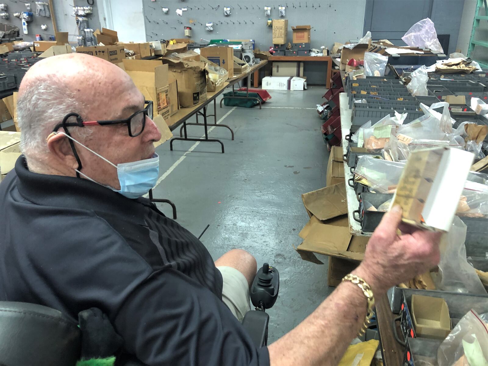 Sandy Mendelson holds NCR parts that his outlet store sells. CORNELIUS FROLIK / STAFF