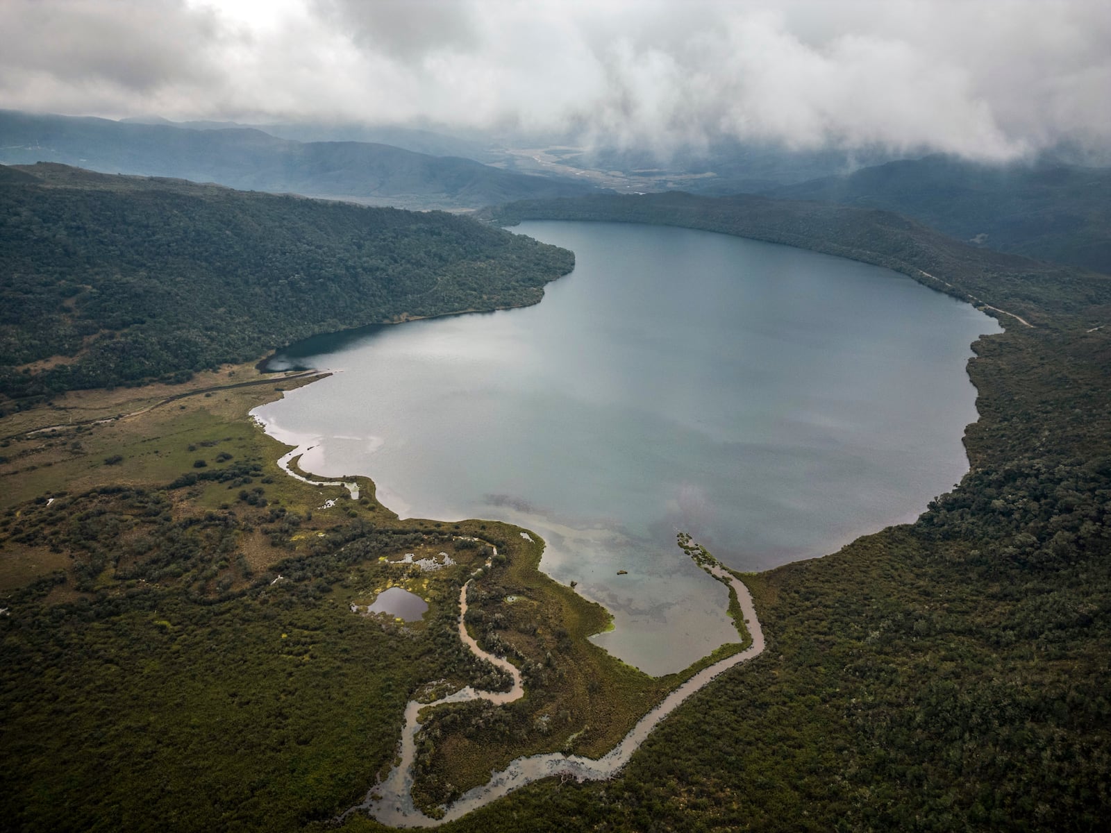 FILE - Clouds float over the Chingaza lagoon in the paramo of Chingaza National Natural Park, Colombia, March 19, 2024, the primary water source for millions of residents in the capital city of Bogota. (AP Photo/Ivan Valencia, File)