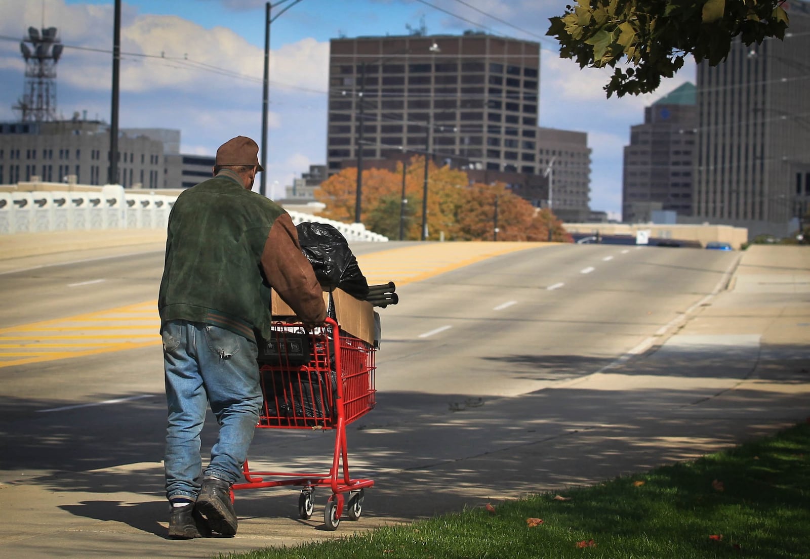 A pedestrian pushes a shopping cart with belongings across the Fourth Street bridge towards the Dayton skyline. From 2007, before the Great Recession, to 2012, when the economic recovery was supposed to be well under way, the median income for Ohio's 4.6 million households fell by 9.2 percent, or almost $4,800 after adjustment for inflation. That was the 10th-worst drop among the 50 states and the District of Columbia during the seven-year period.Ohio families fared slightly better. The median income for the state's 2.9 million families declined by 7.0 percent or close to $4,600. That was the 16th-worst drop in the nation.JIM WITMER / STAFF